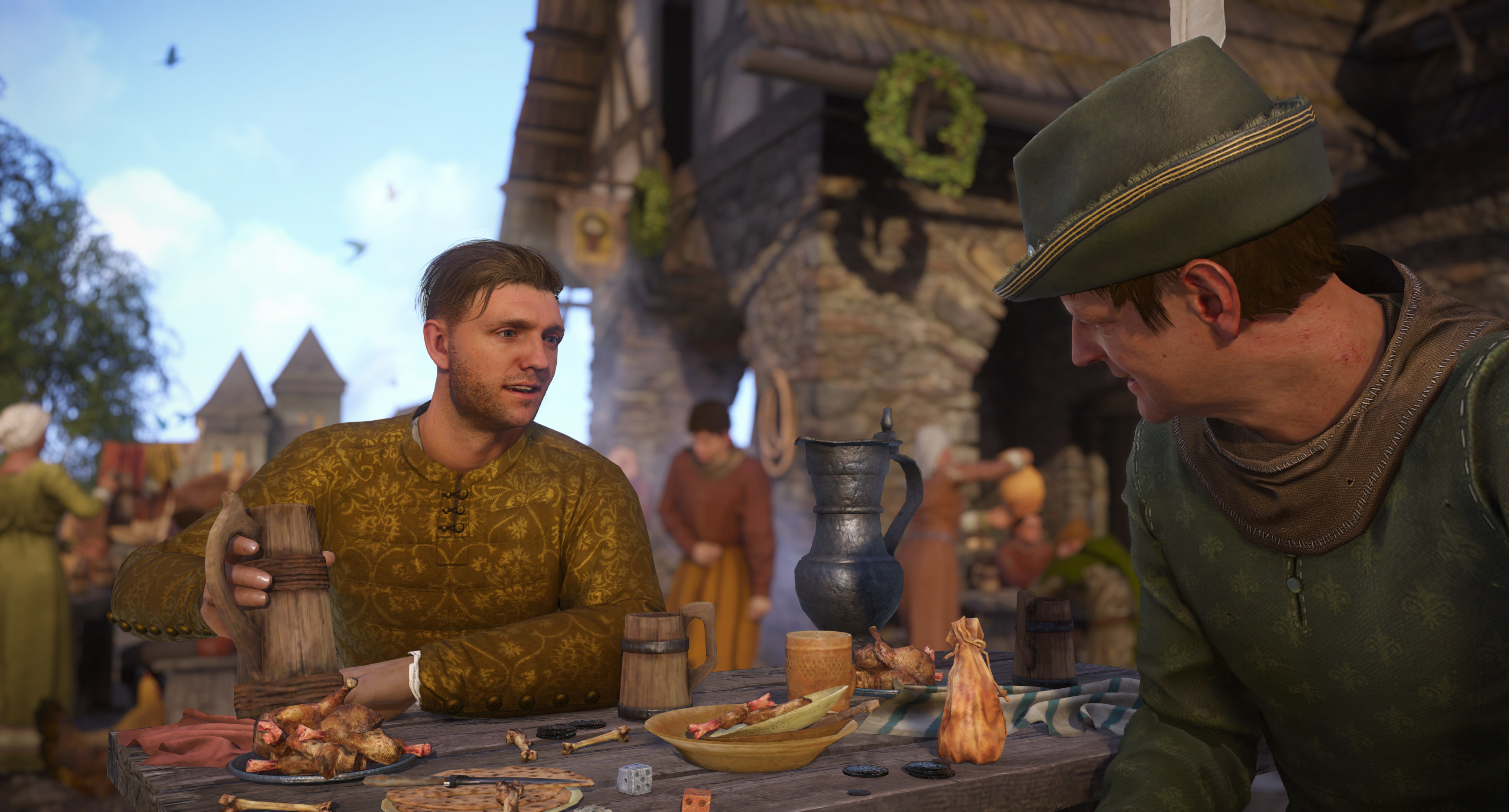 Deux hommes assis à une table avec de la nourriture et des boissons dehors.