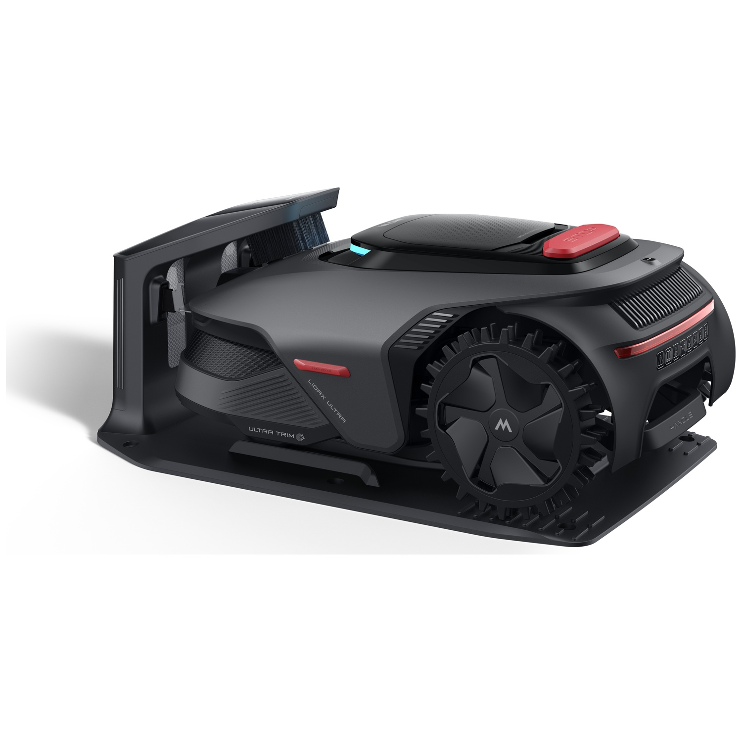 A black robotic lawn mower with a red stop button rests on its charging station.