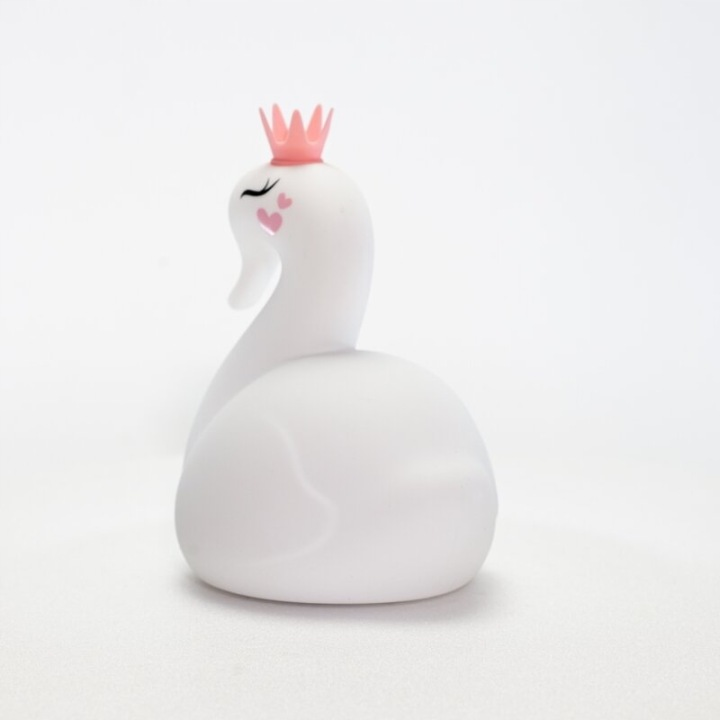 Biała figurka łabędzia z różową koroną i serduszkami na policzku.