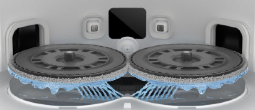 Dwa obracające się szczotki z dyszami wodnymi pod urządzeniem.