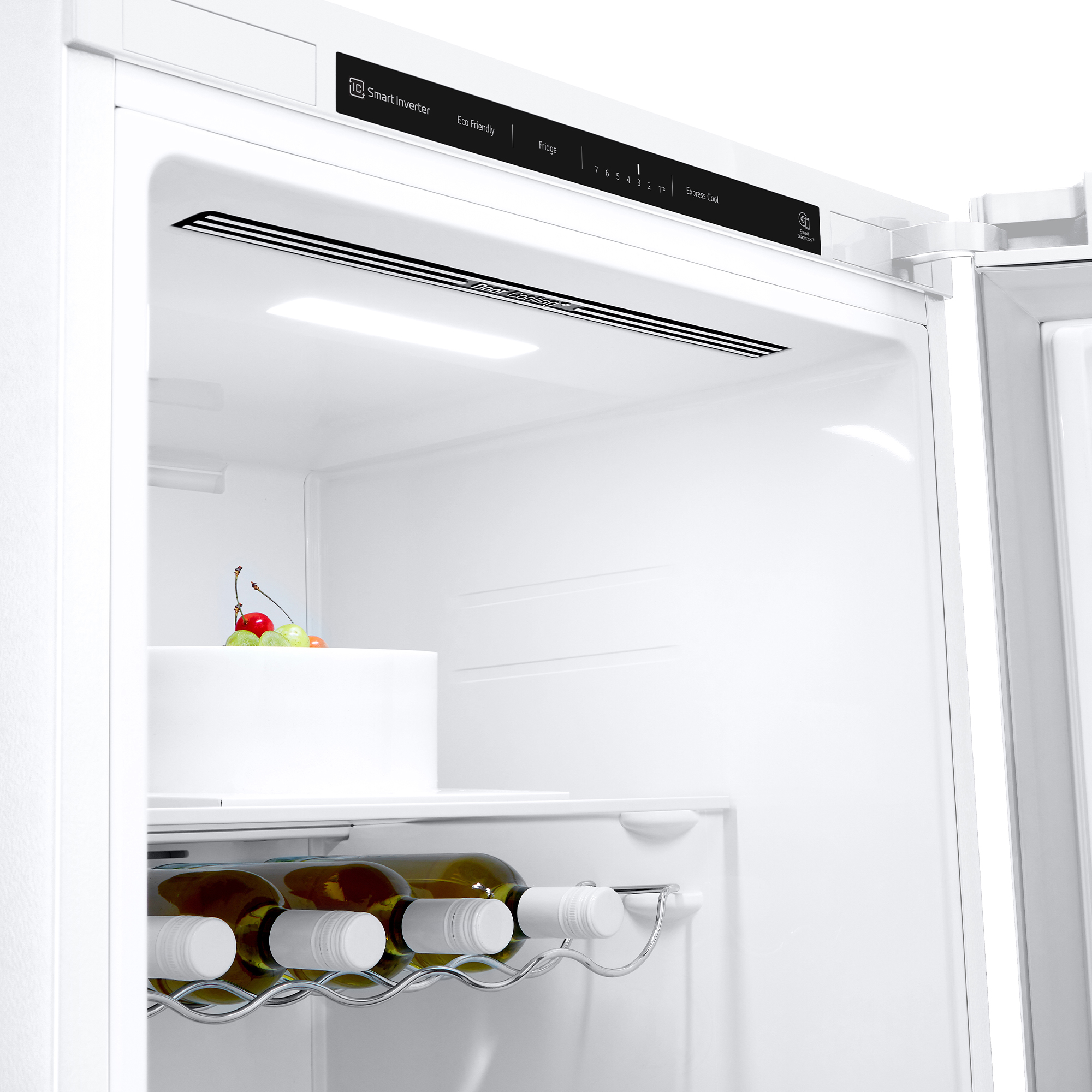 Interior de un refrigerador con una botella de vino y fruta en el estante.