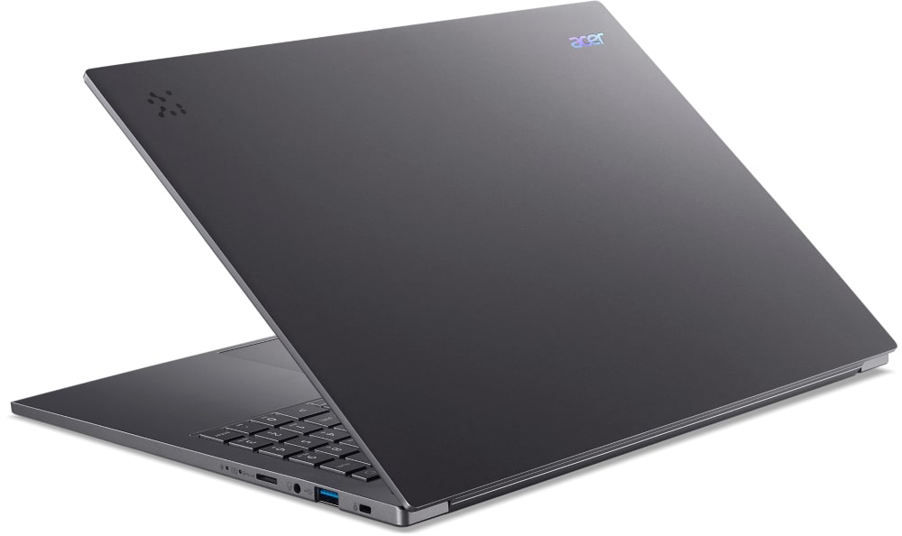 Egy szürke Acer laptop nyitott állapotban, billentyűzettel és portokkal.