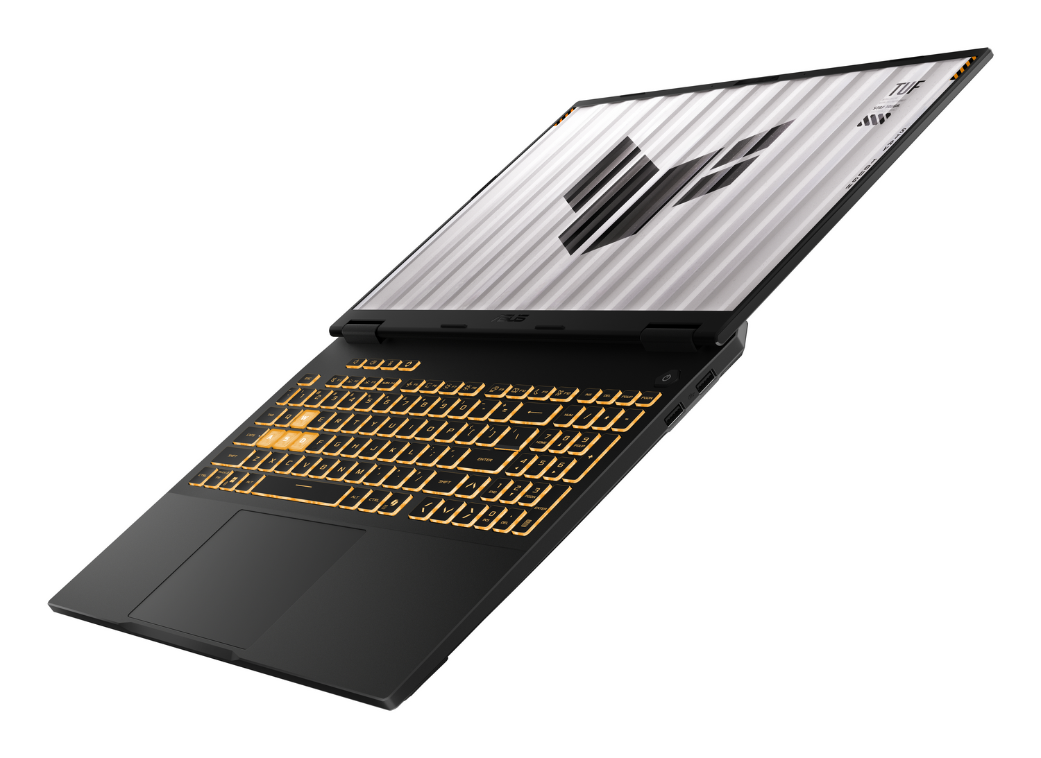 Un portátil negro con teclado amarillo retroiluminado y logo TUF en pantalla.