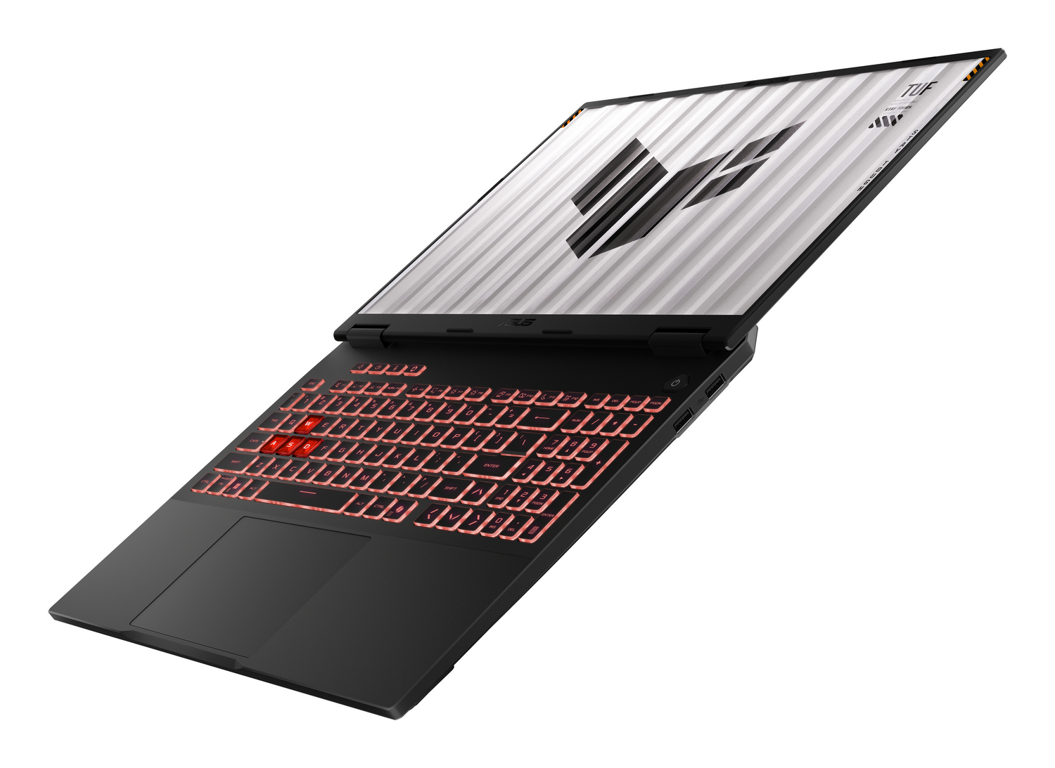 Portátil negro con teclado iluminado y logo de TUF en pantalla.