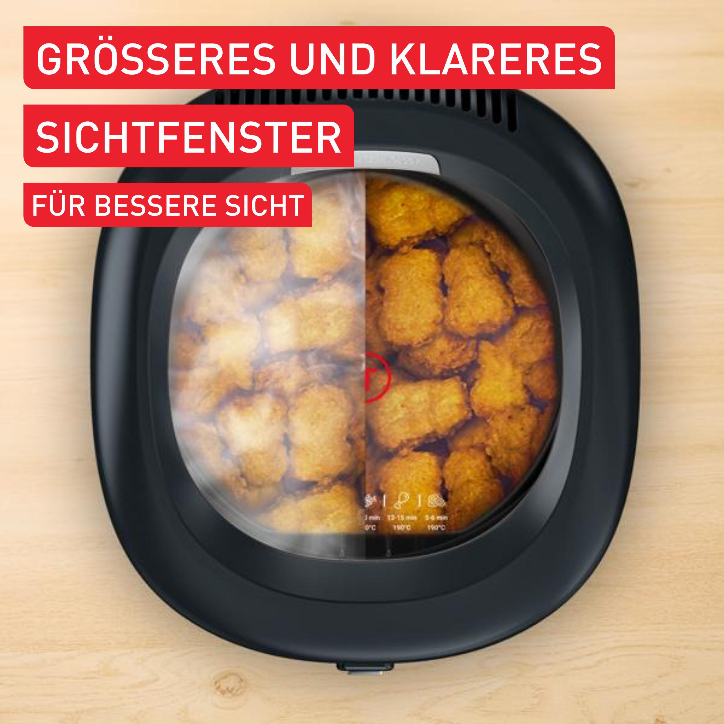 Ein Airfryer mit einem geteilten Sichtfenster, das Essen zeigt.