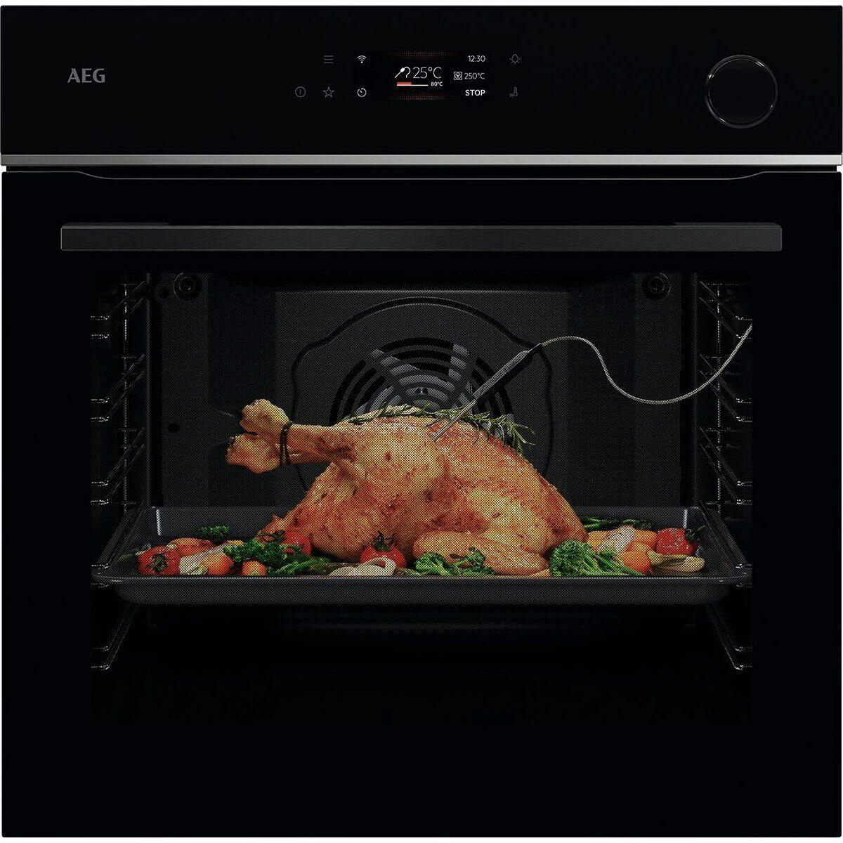 Ein gebratenes Huhn mit Gemüse in einem Ofen auf einem Blech, mit einem Thermometer.