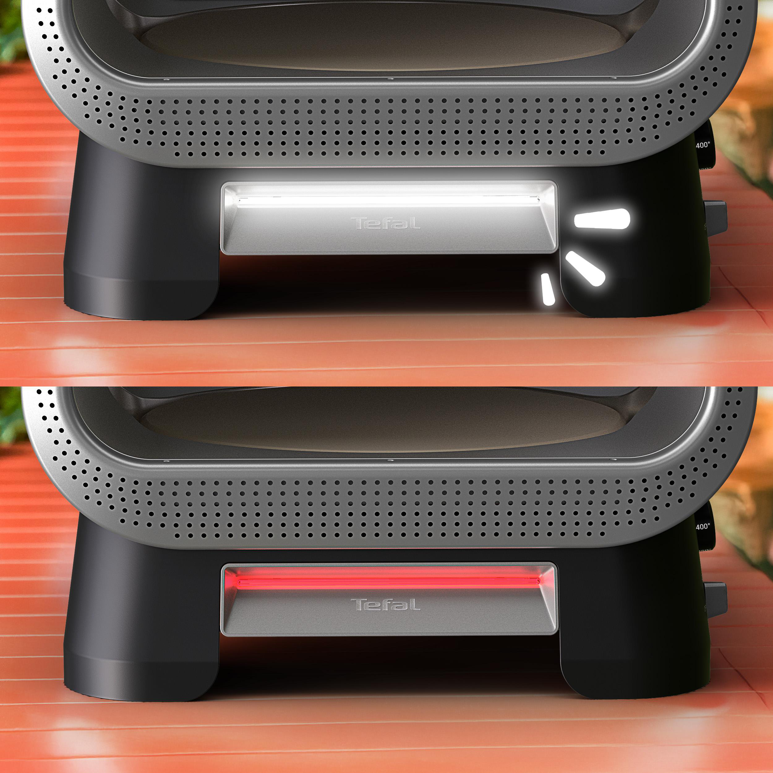 Ein Tefal-Ofen mit rotem oder weißem Licht auf einem orangefarbenen Tisch.