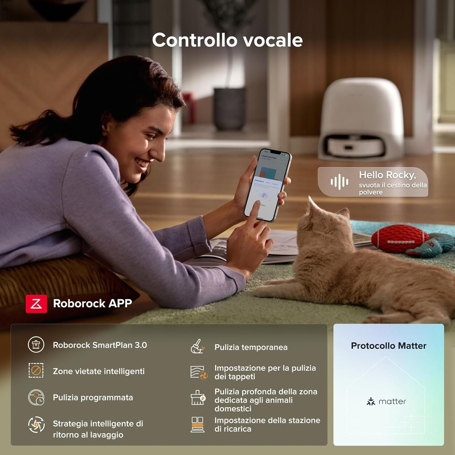 Una donna usa un telefono con un'app di robot aspirapolvere mentre un gatto guarda.