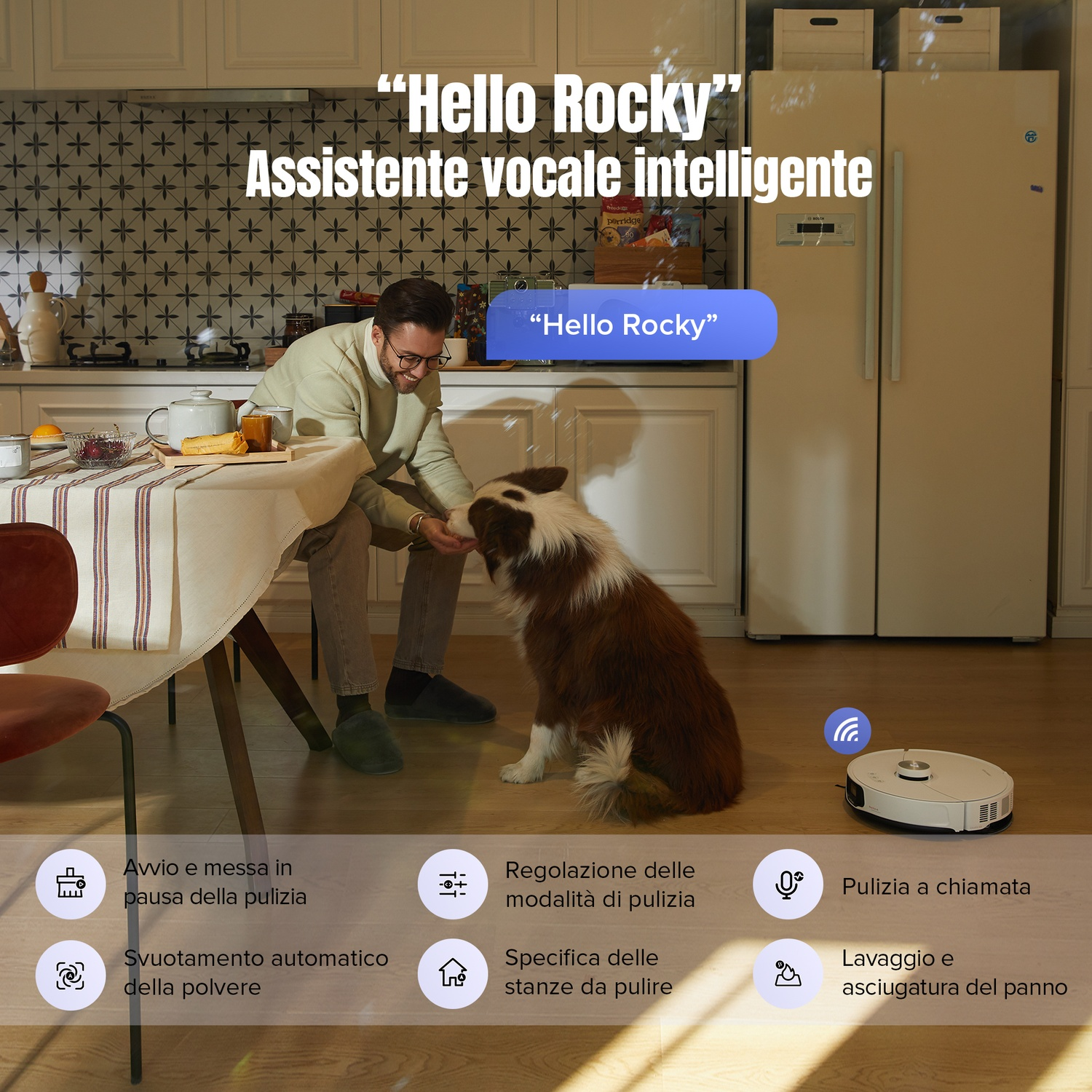 Uomo dà da mangiare al cane in cucina; robot aspirapolvere.