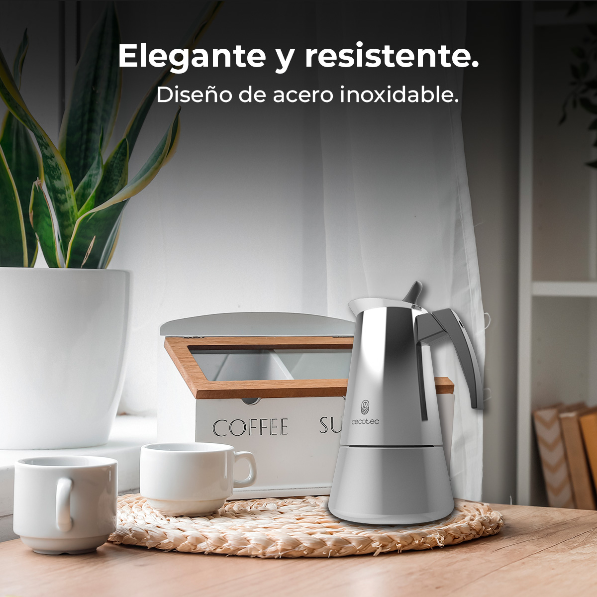 Elegante cafetera moka con dos tazas y un set de botes de café.