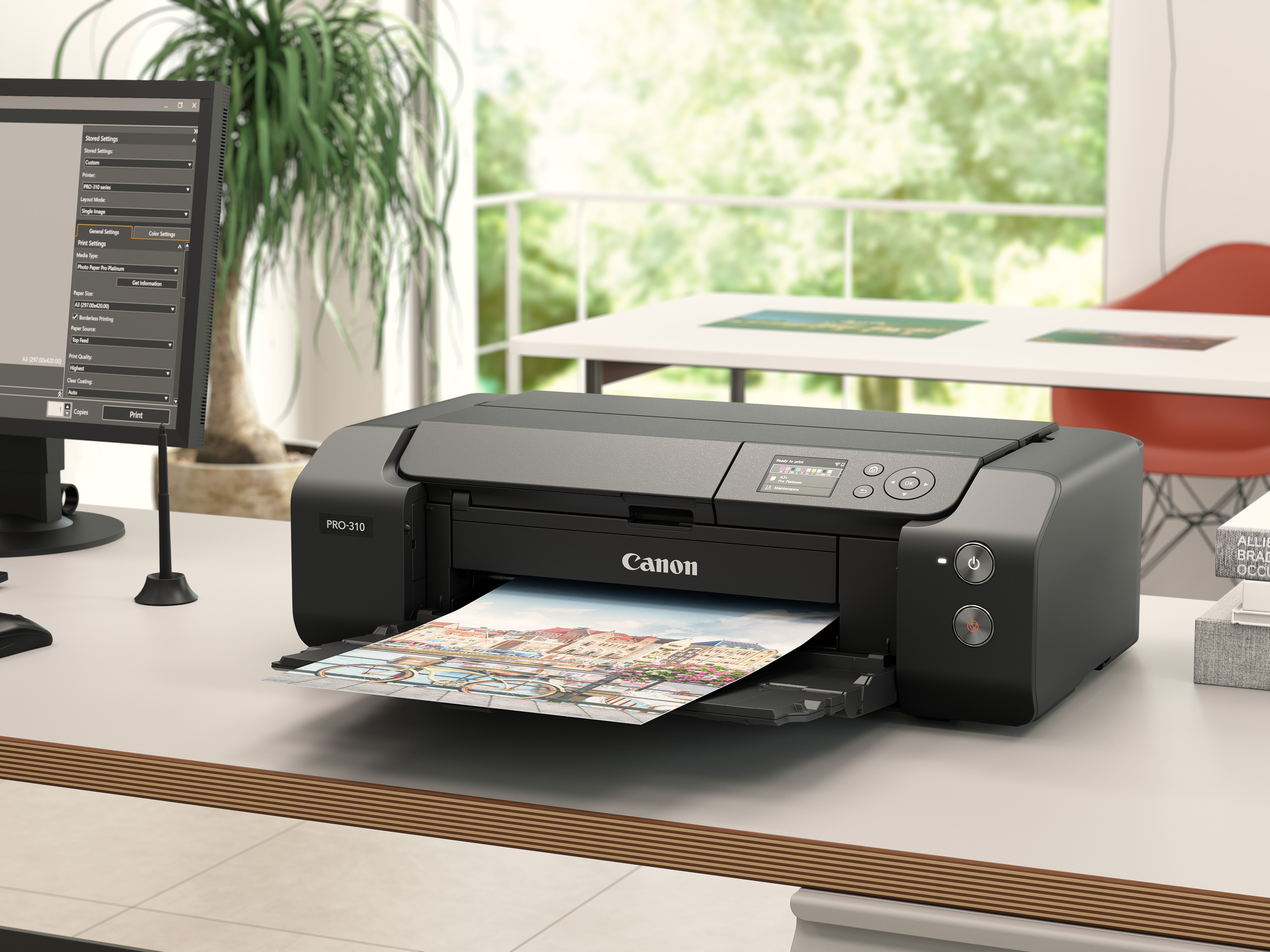 Czarna drukarka Canon Pro-310 drukuje widok miasta z rowerami.