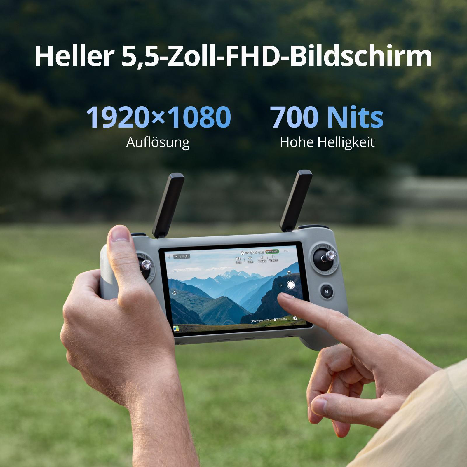 Person hält Drohnenfernbedienung mit Berglandschaft auf dem Bildschirm.