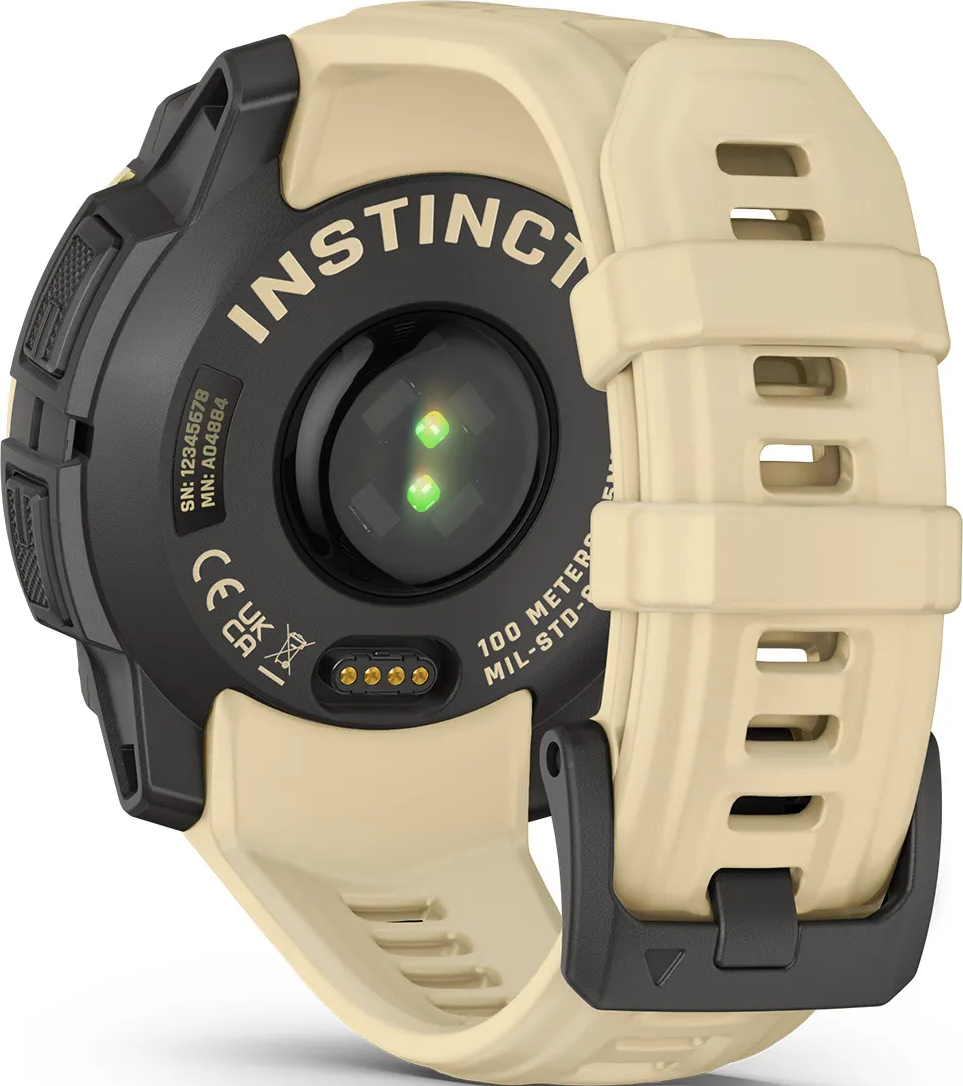 Arrière d'une montre Garmin Instinct beige avec cardiofréquencemètre et broches de chargement.