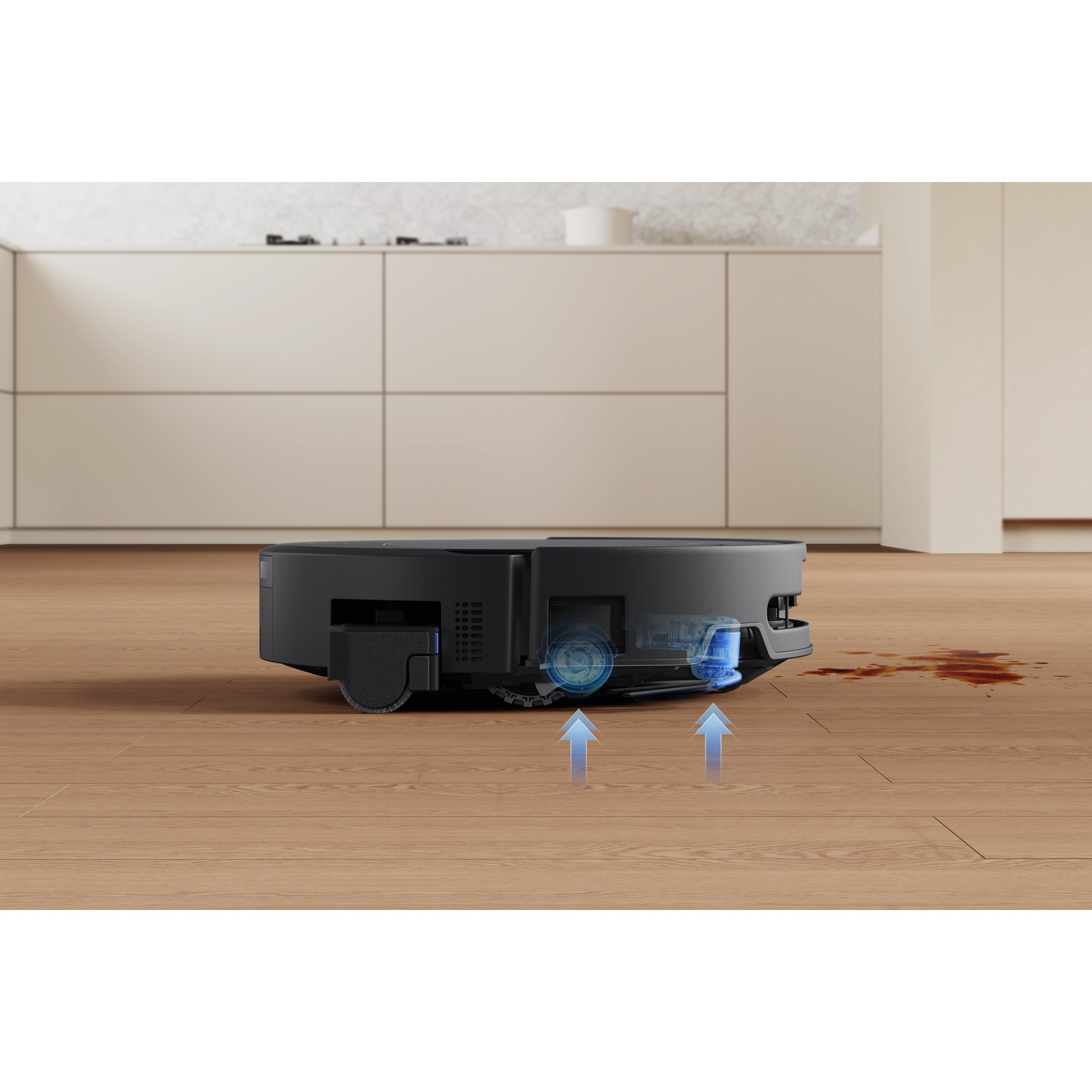 Un robot aspirapolvere nero su parquet che assorbe liquido.