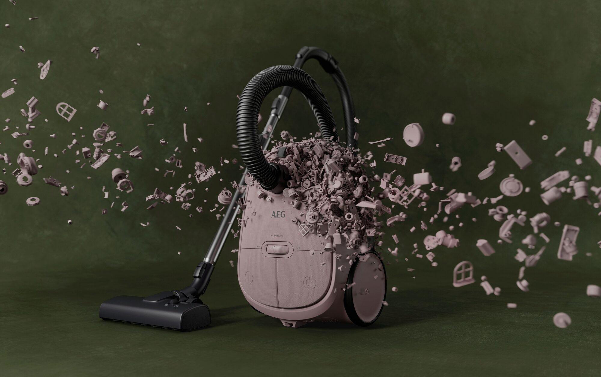 Ein rosa Staubsauger explodiert in kleine Teile vor dunklem Hintergrund.