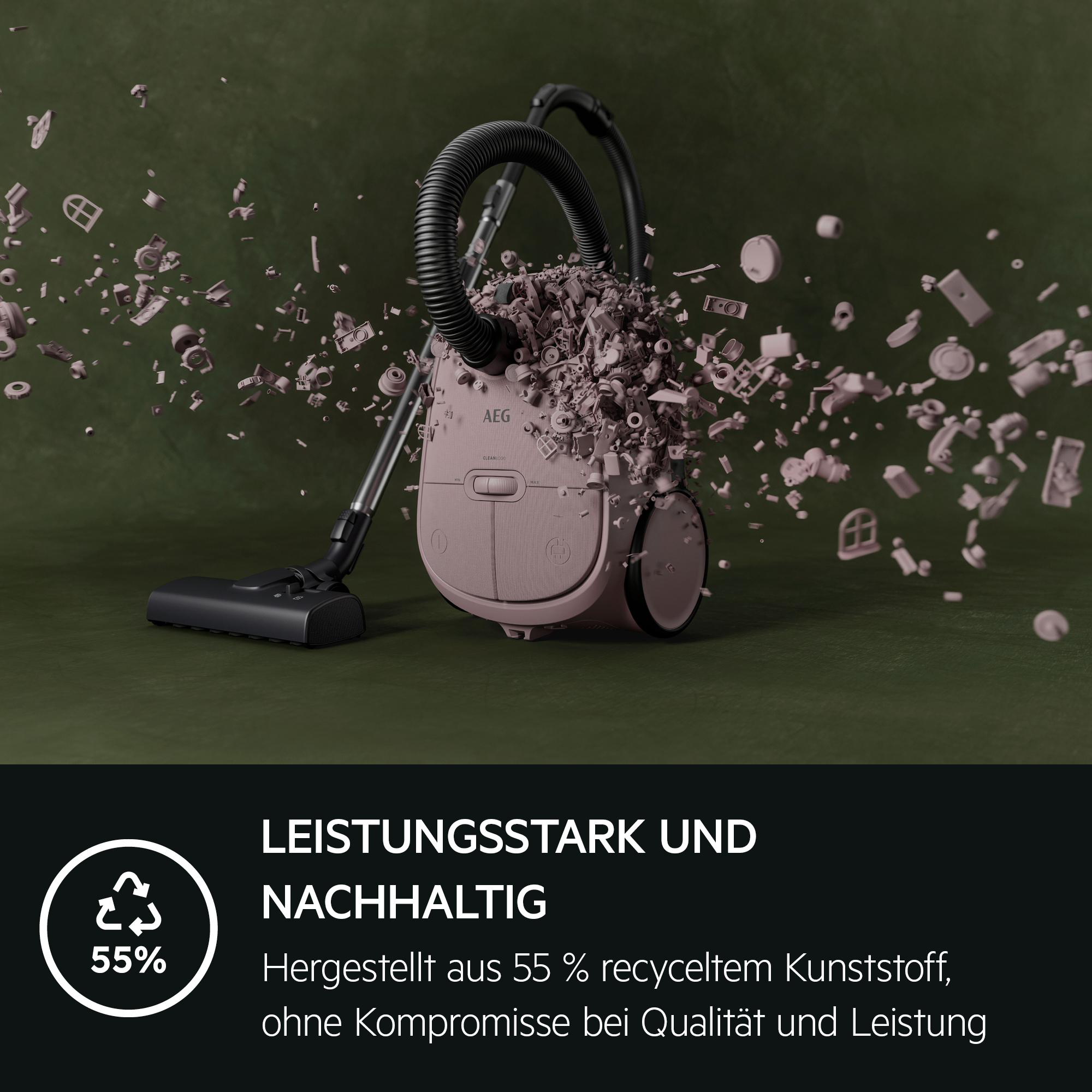 Ein rosa Staubsauger mit Schlauch, umgeben von fliegenden Kleinteilen.