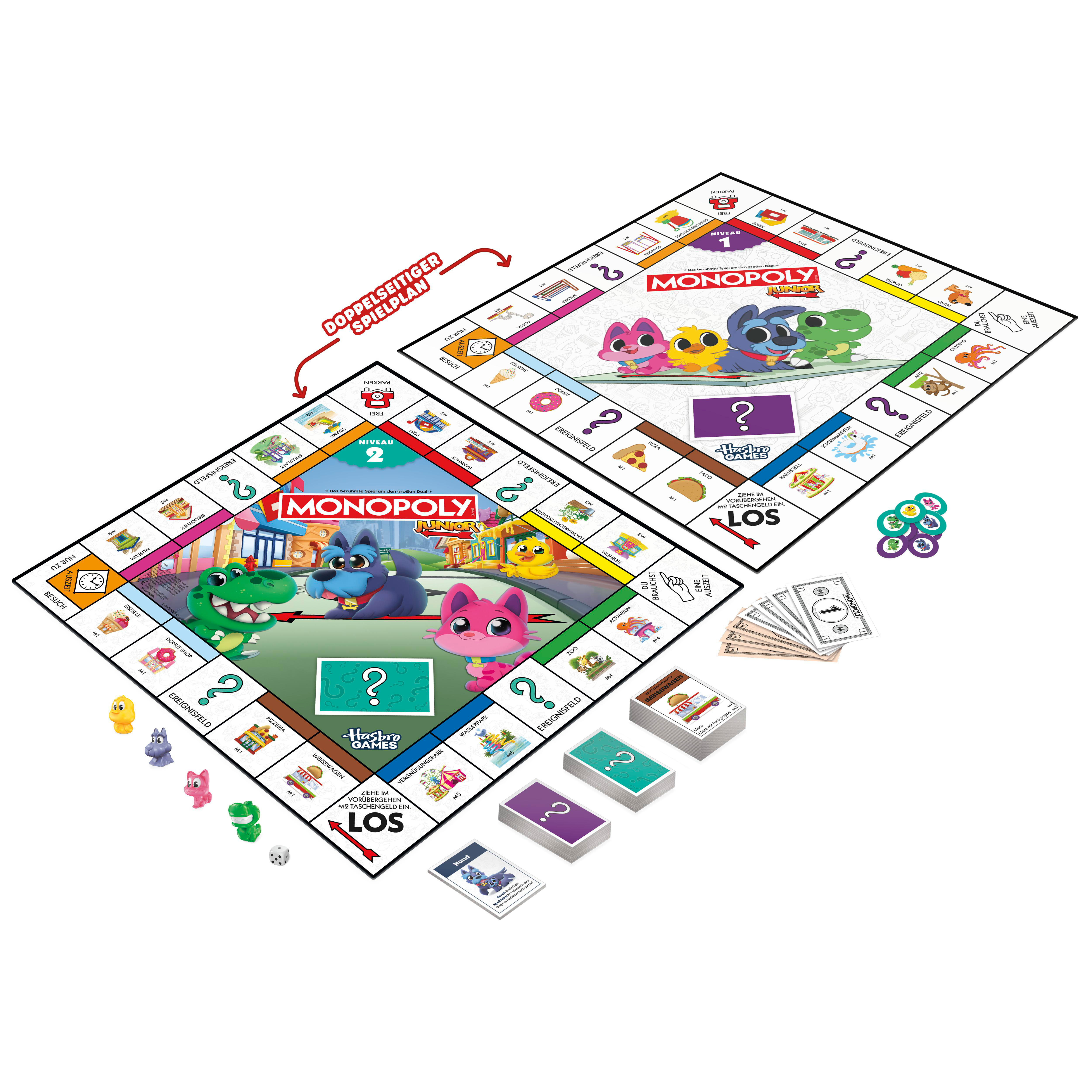 Monopoly Junior Spielbrett mit bunten Figuren, Spielgeld und Würfeln.