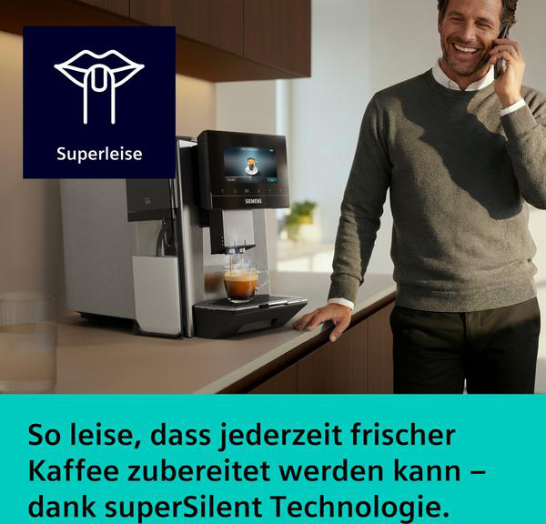 Ein Mann telefoniert neben einer Kaffeemaschine, die Kaffee zubereitet.