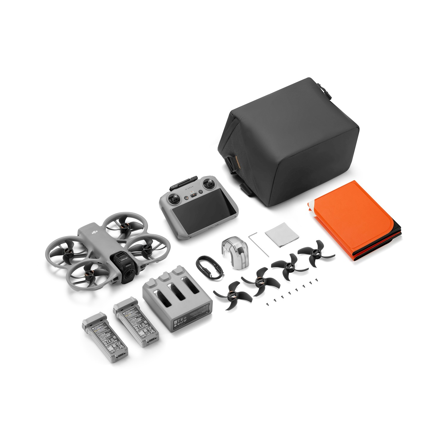 Kit drone grigio con telecomando, batterie, eliche e borsa.