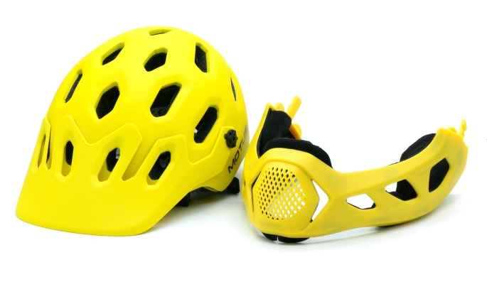 Żółty kask i zdejmowany ochraniacz podbródka z otworami wentylacyjnymi.