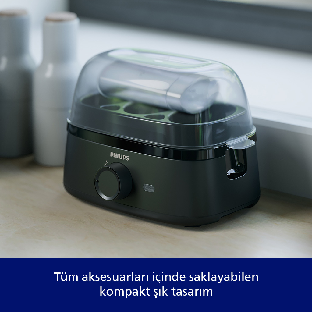 Şeffaf kapaklı koyu renkli Philips sterilizatör ahşap masanın üzerinde duruyor.