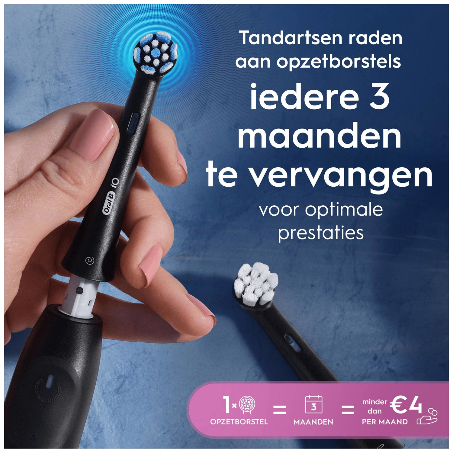 A black Oral-B iO handle is shown, with a brush head attachment. Another brush head lies nearby.