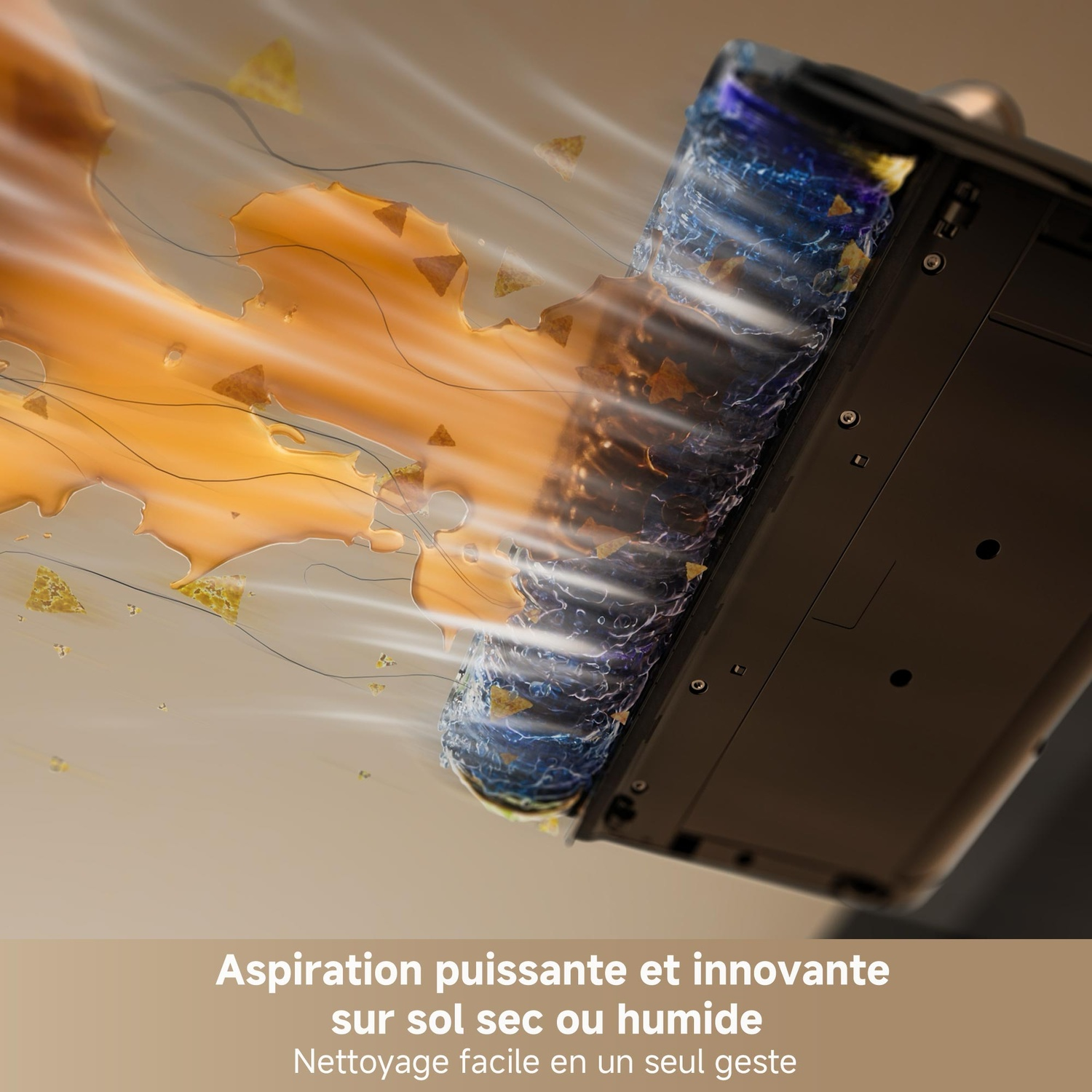 Une brosse rotative aspire un liquide orange et des particules.