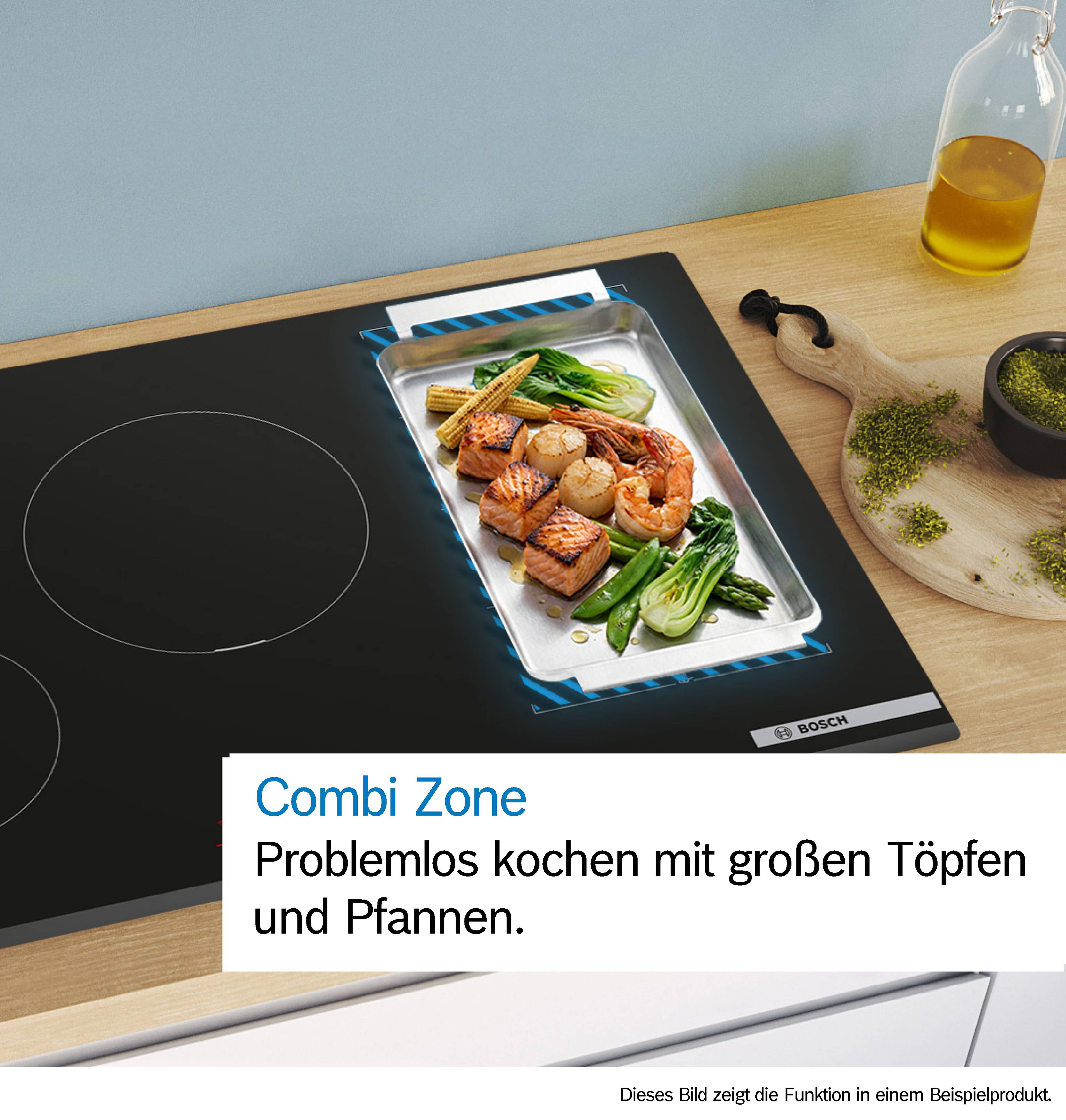 Ein Induktionskochfeld mit gebratenem Fisch, Garnelen und Gemüse in einer Schale.