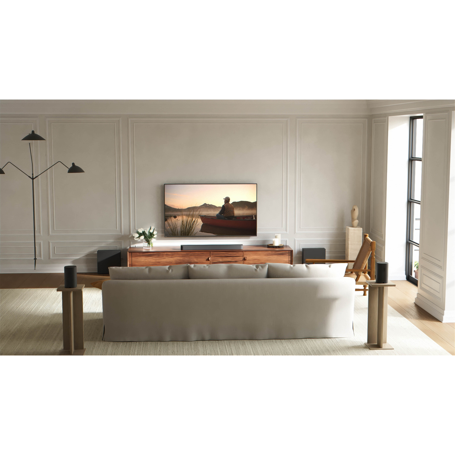 A living room featuring a sofa, TV displaying a person in a canoe.