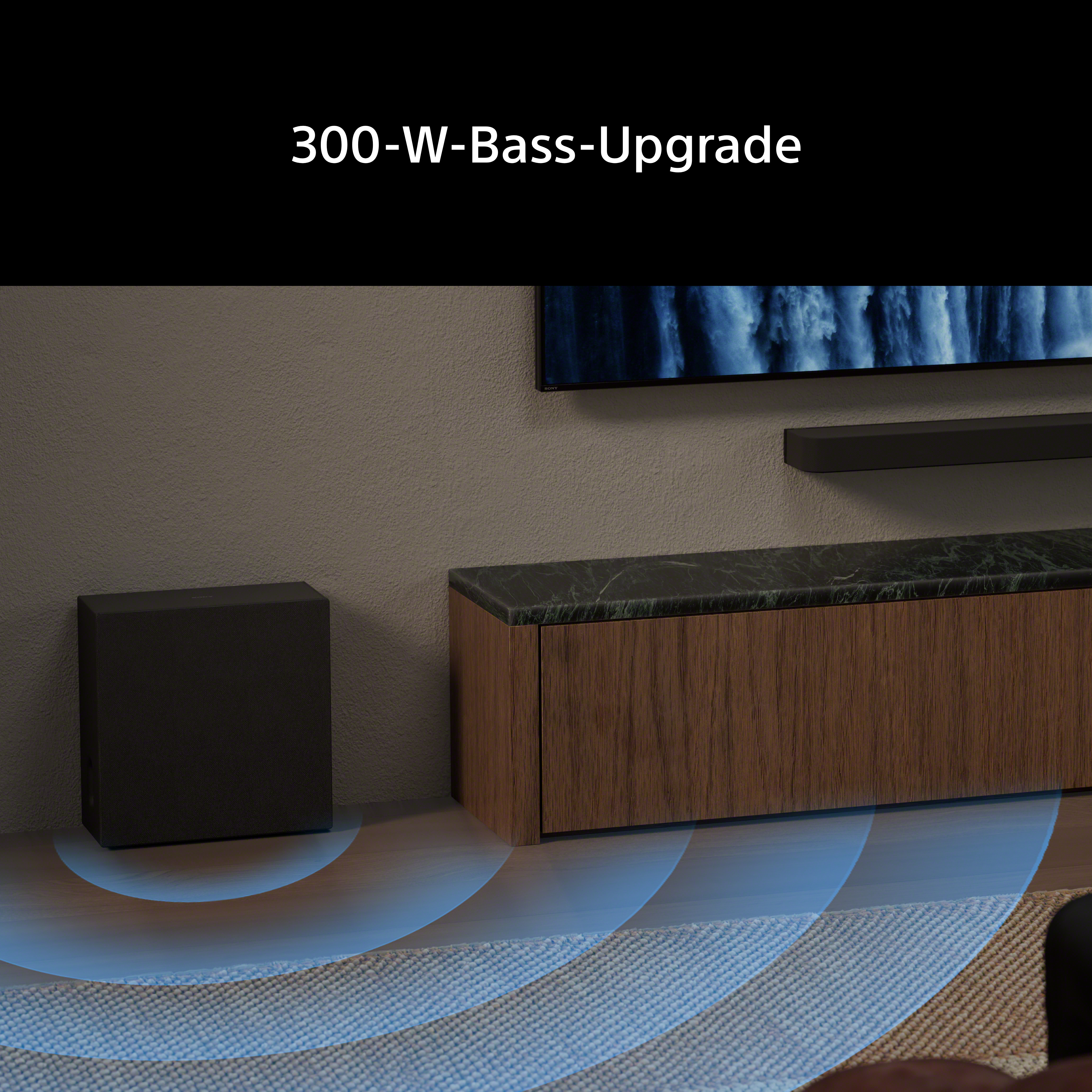 Schwarzer Subwoofer steht neben einem Holzmöbel. Blaue Wellen auf dem Boden.