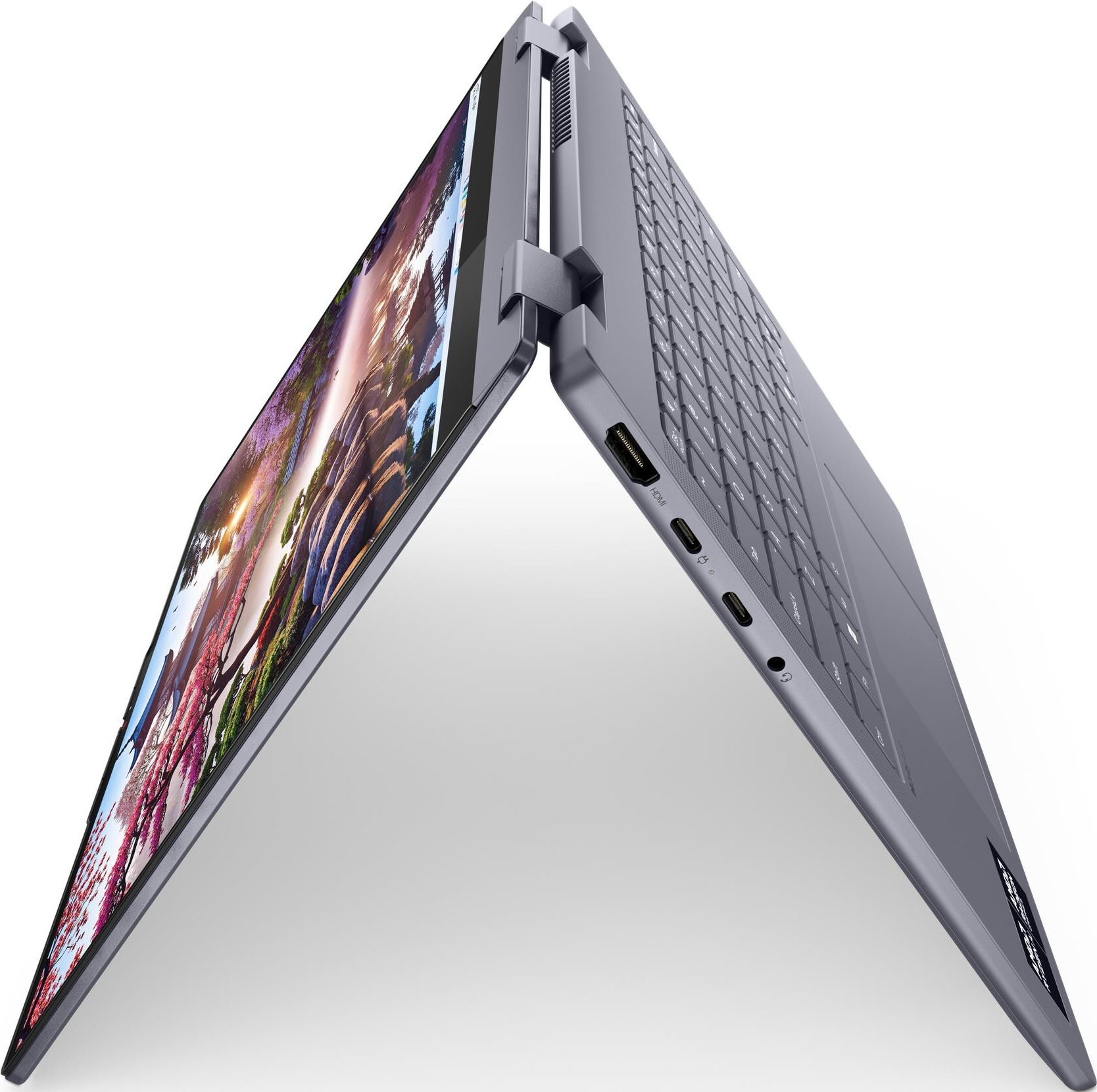 Ein graues Laptop mit aufgeschlagenem Bildschirm, der ein farbenfrohes Bild zeigt.