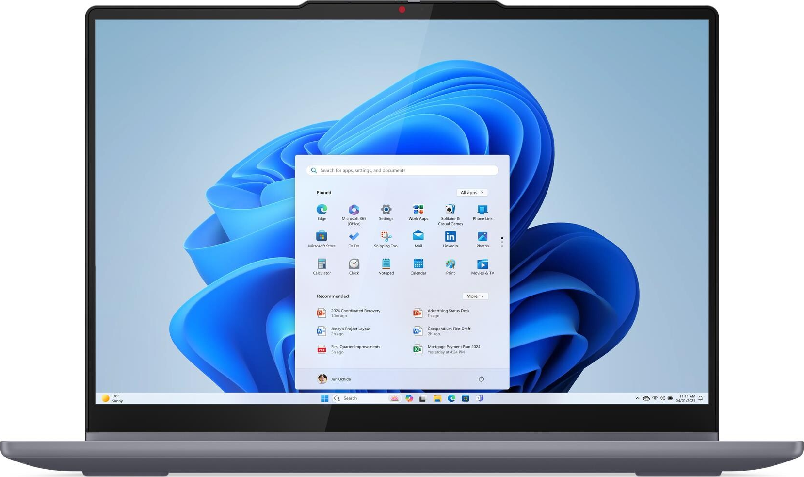 Ein Laptop zeigt den Windows 11 Startbildschirm mit blauen Wellen. Ein Menü ist geöffnet.
