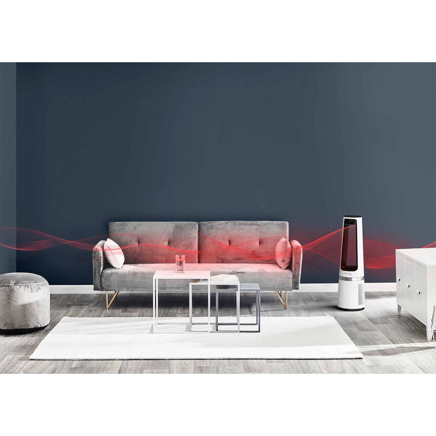 A modern living room with a gray sofa, side tables, white rug and a heater.