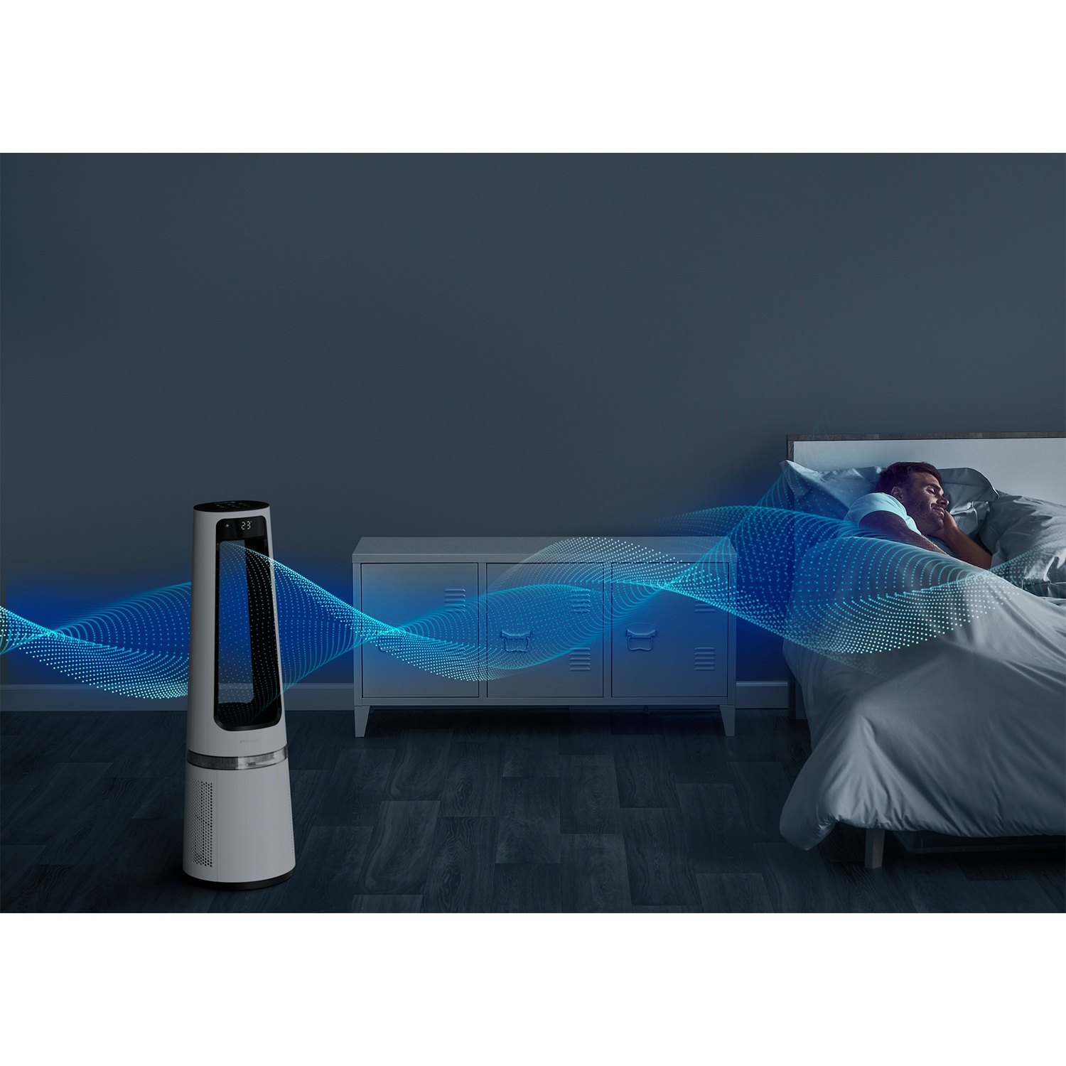 A man sleeps in bed as a white tower fan generates blue air waves.