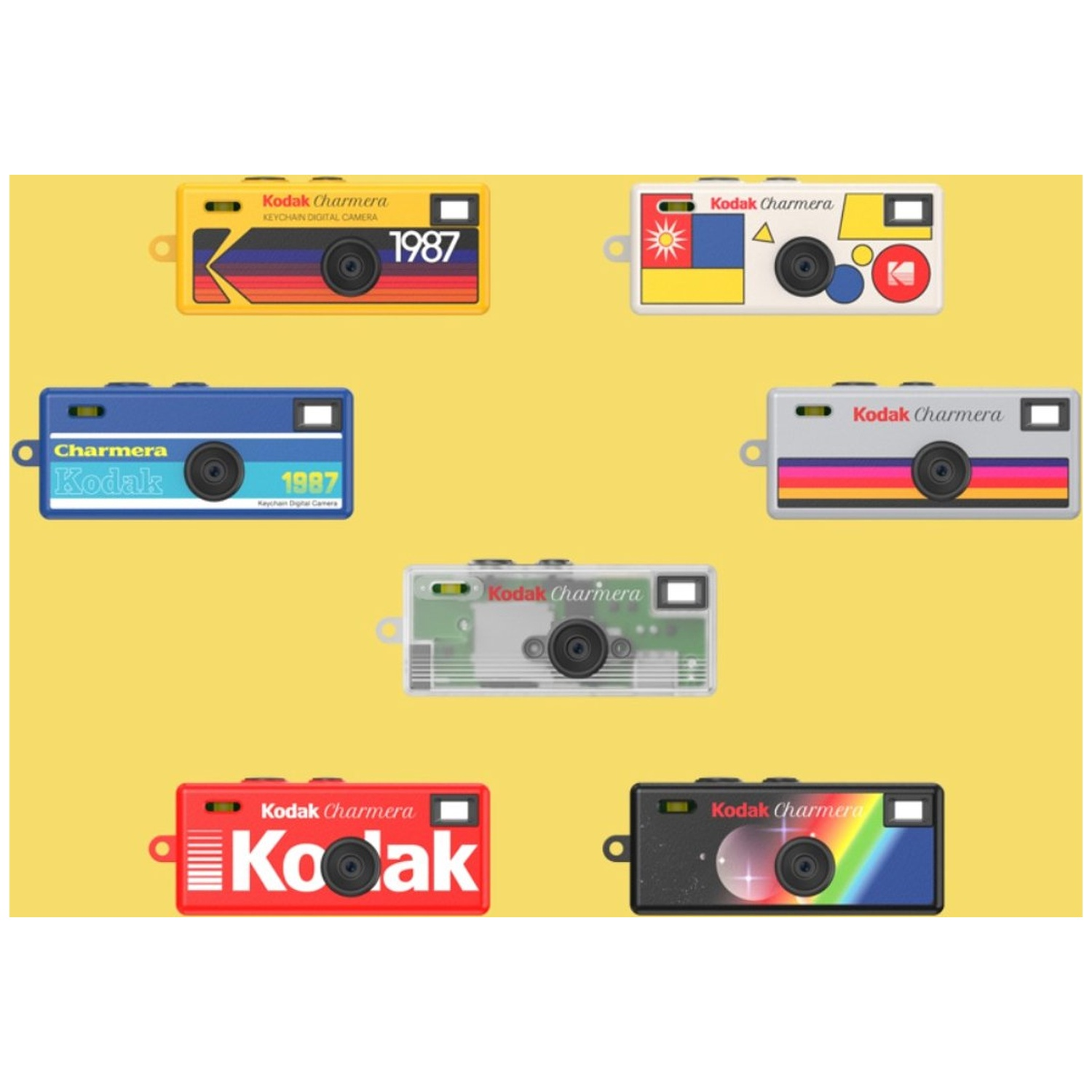 Seven colorful Kodak Charmera keychain digital cameras arranged on a yellow background.