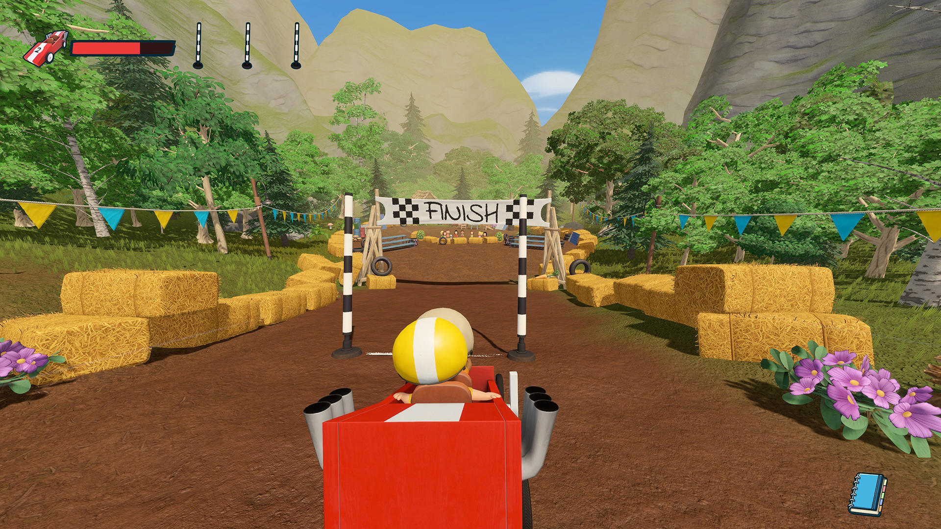 Rotes Go-Kart nähert sich der Ziellinie mit Strohballen und Bannern.