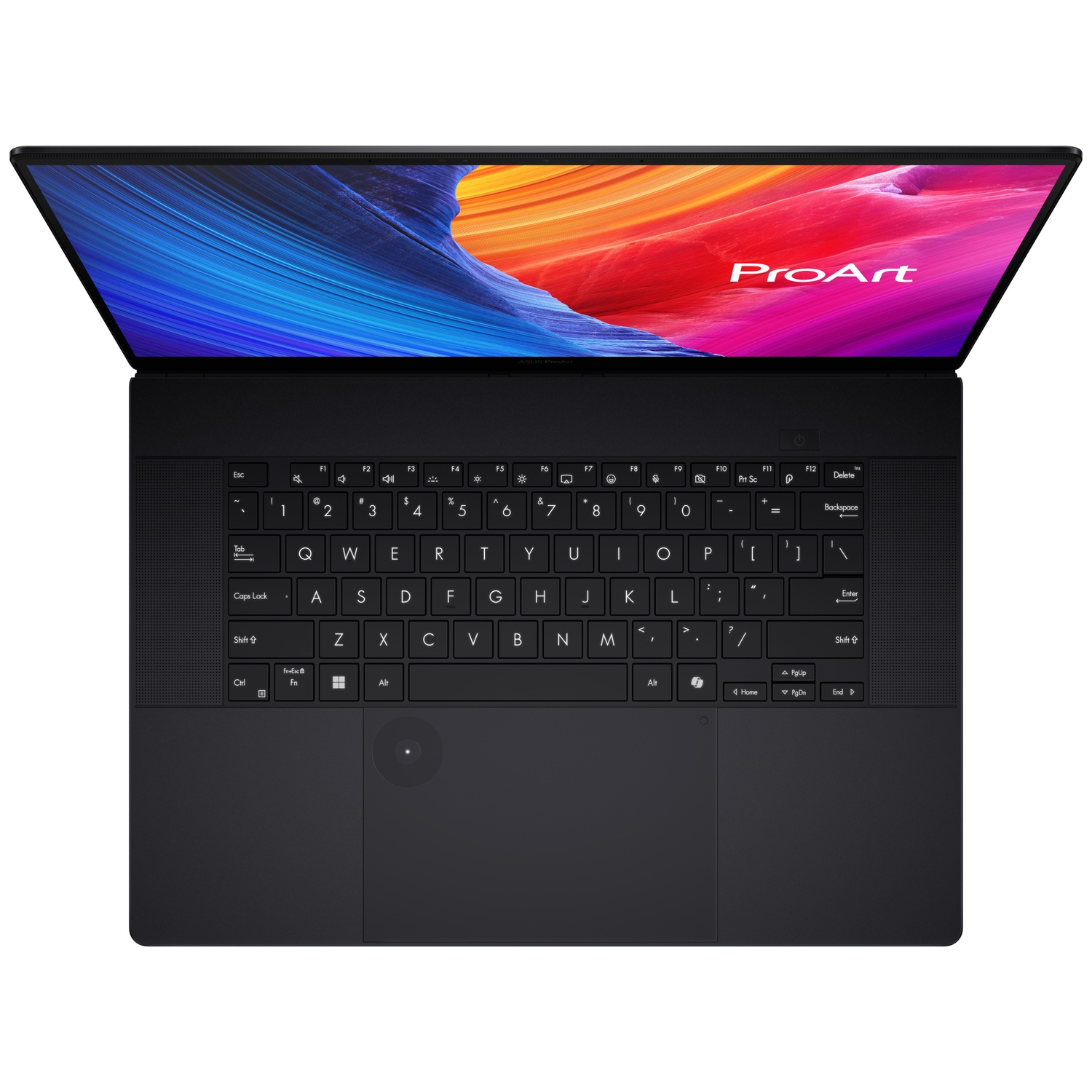 A black Asus ProArt laptop open, showing the screen with colorful abstract art and the keyboard.