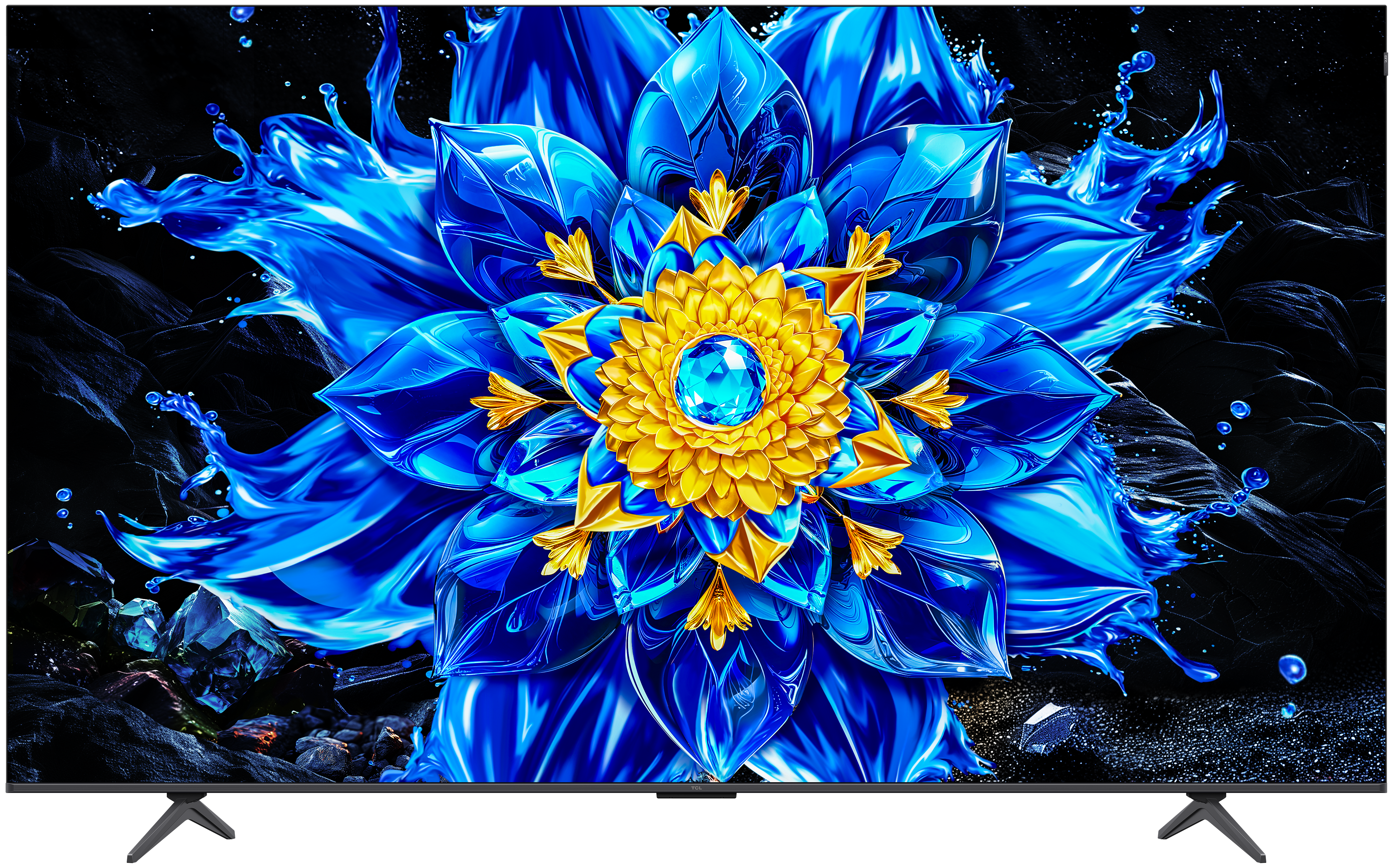 Eine blaue und goldene Blume mit Wasserspritzern auf schwarzem Hintergrund.
