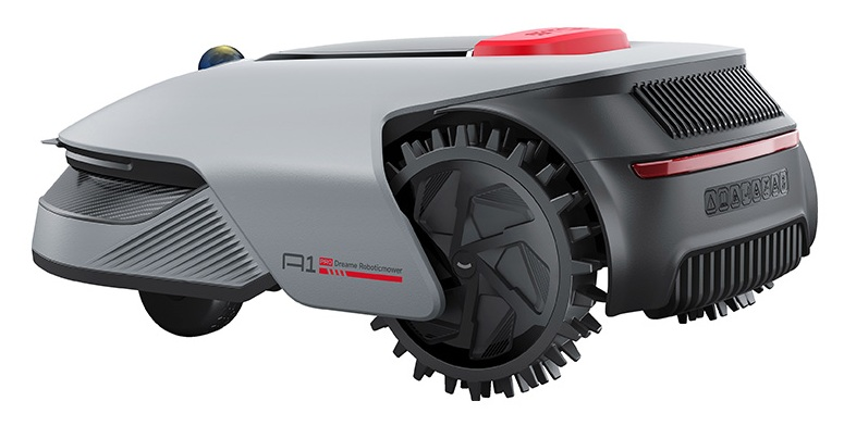 Szara i czarna kosiarka robotyczna z dużymi kolczastymi kołami i czerwonym przyciskiem na górze.