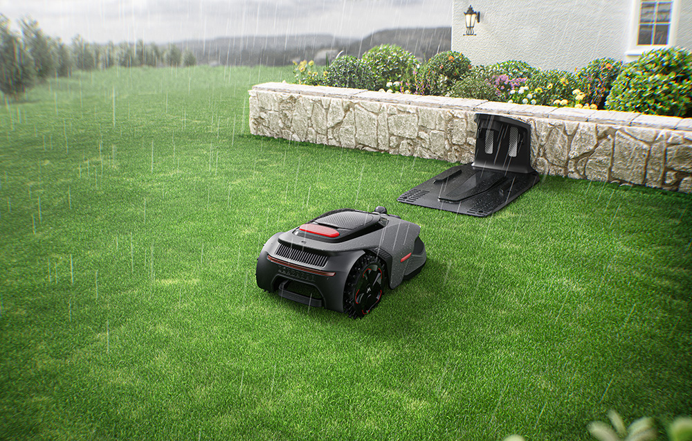 Robot koszący na trawniku podczas deszczu. Stacja ładująca w pobliżu.