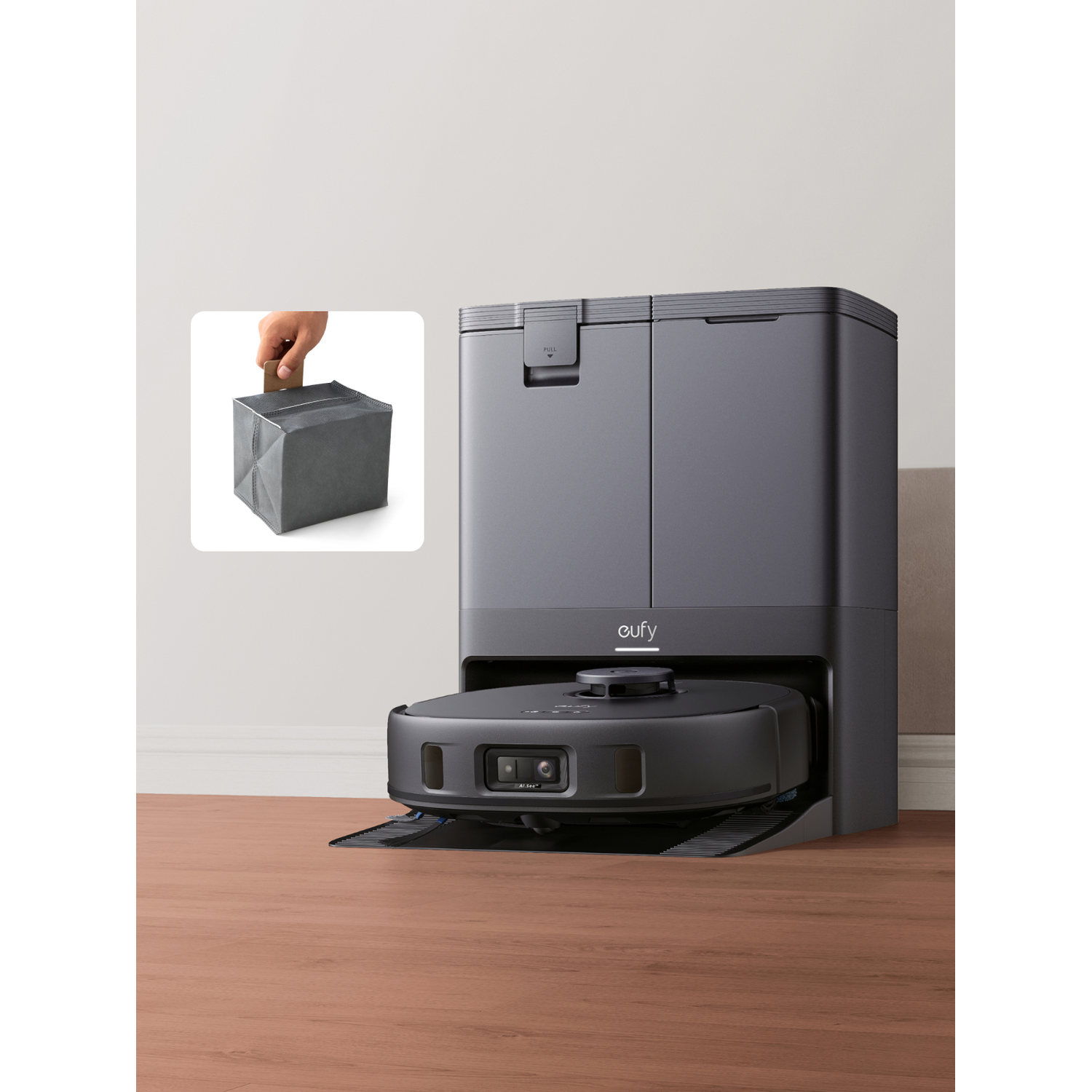 A gray robot vacuum with a docking station and a dustbin insertion detail.