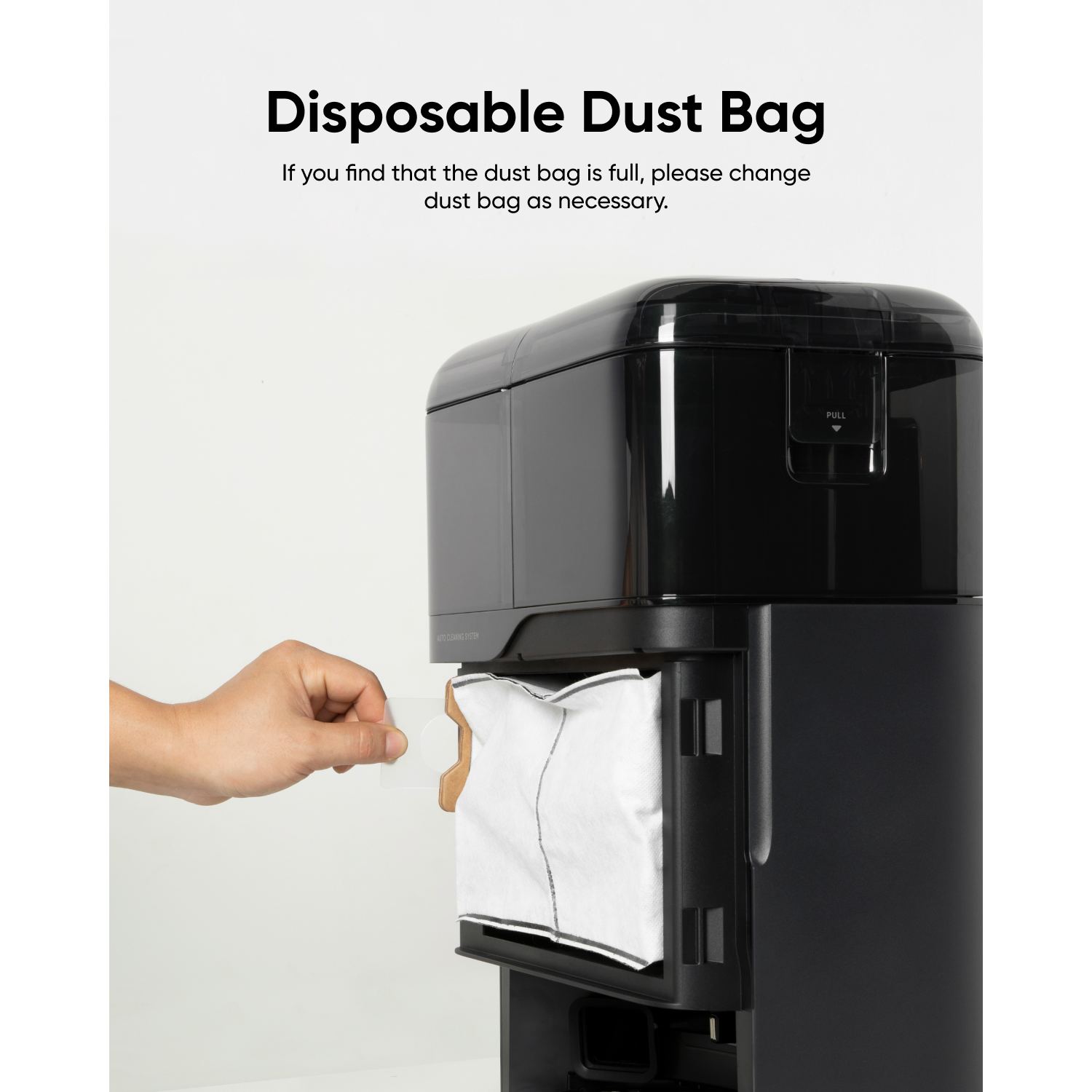 A hand pulls a white dust bag from a black cleaning station.