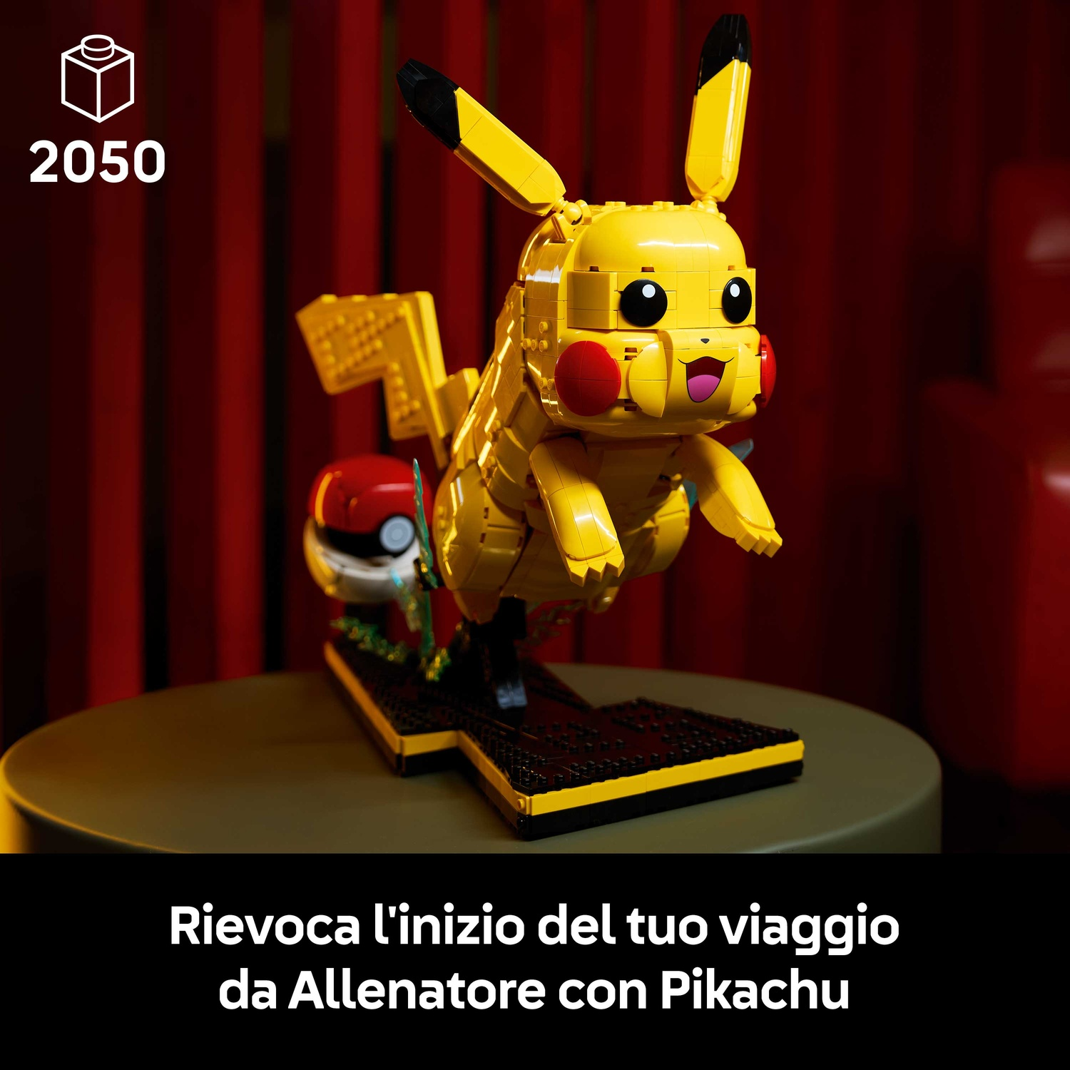 Pikachu LEGO con Pokeball su una base davanti a uno sfondo rosso.