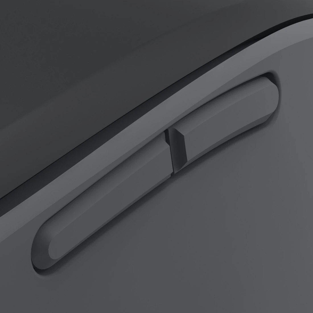 Zbliżenie ciemnoszarego przycisku na krawędzi ciemnej powierzchni.