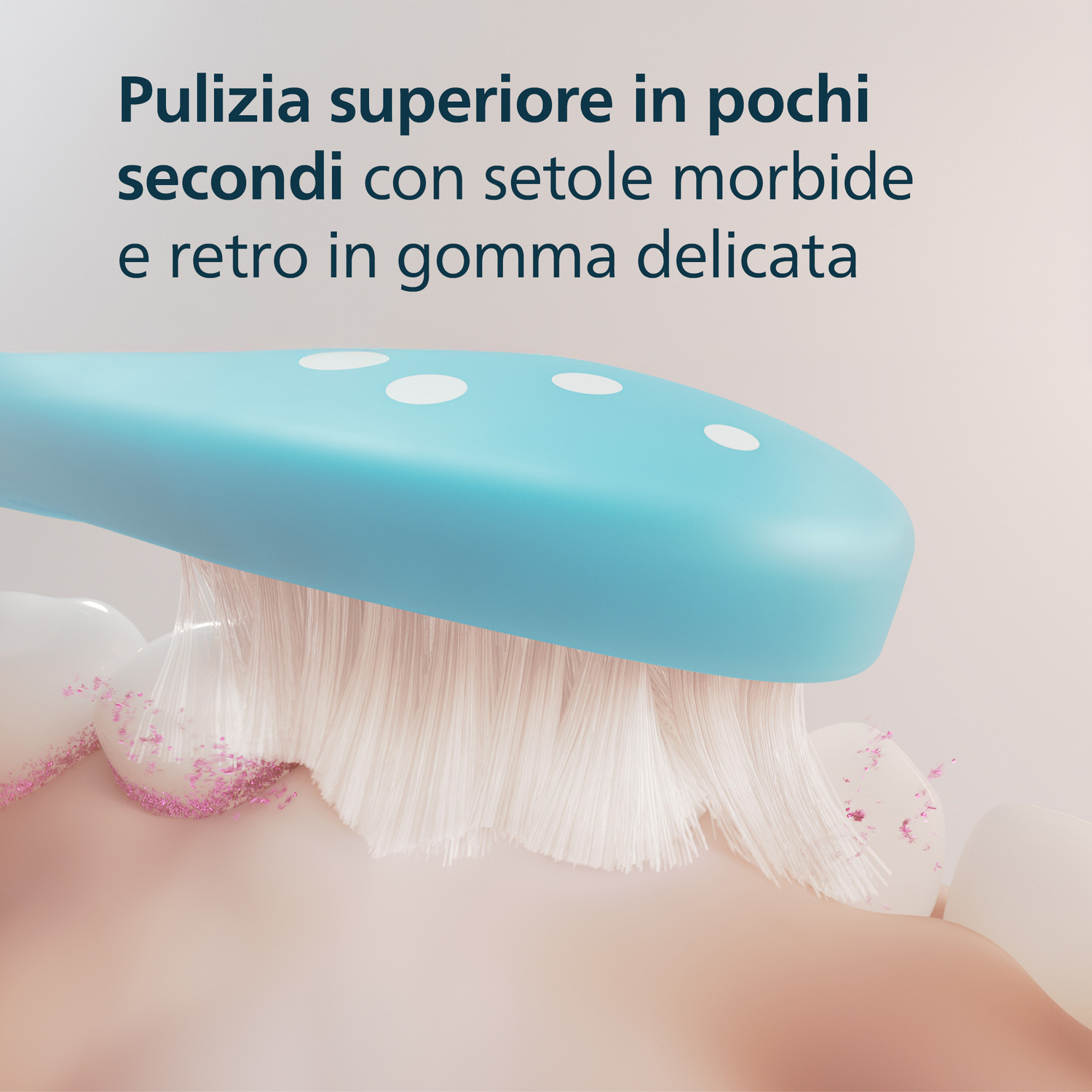 Uno spazzolino azzurro pulisce denti bianchi con particelle rosa.