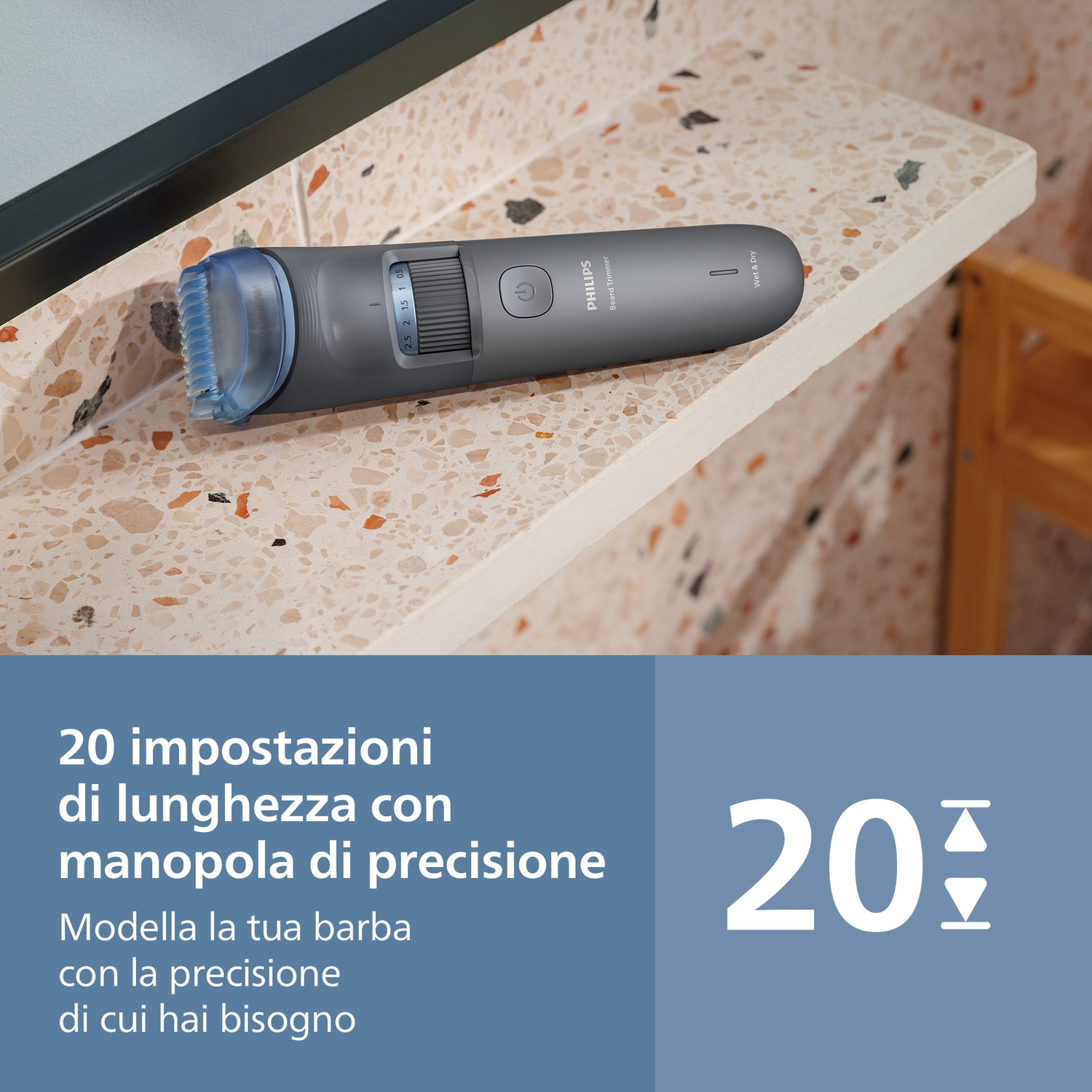 Regolabarba Philips grigio con accessorio blu e impostazioni di lunghezza su piano.