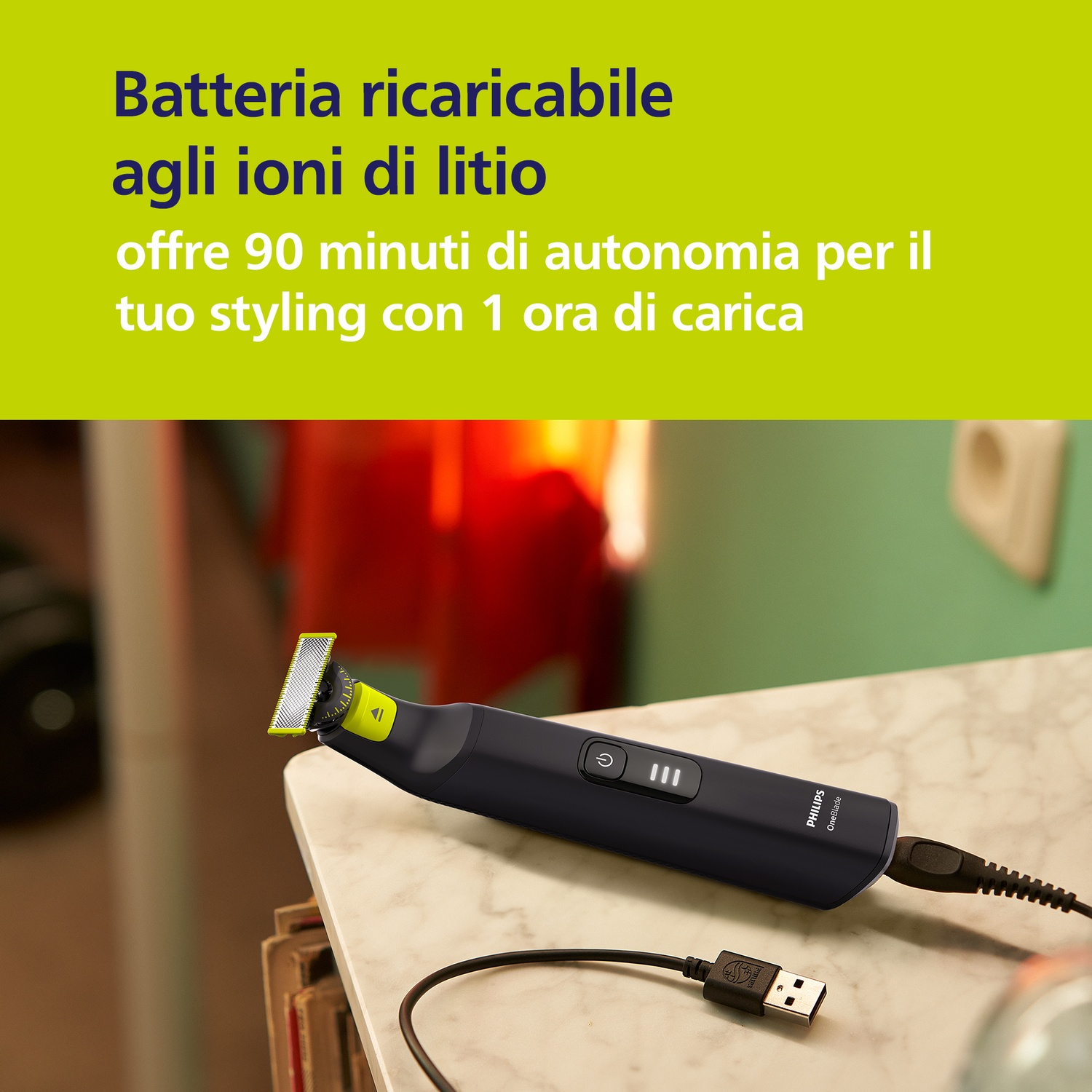 Un rifinitore Philips OneBlade nero con accento giallo, in carica via USB.