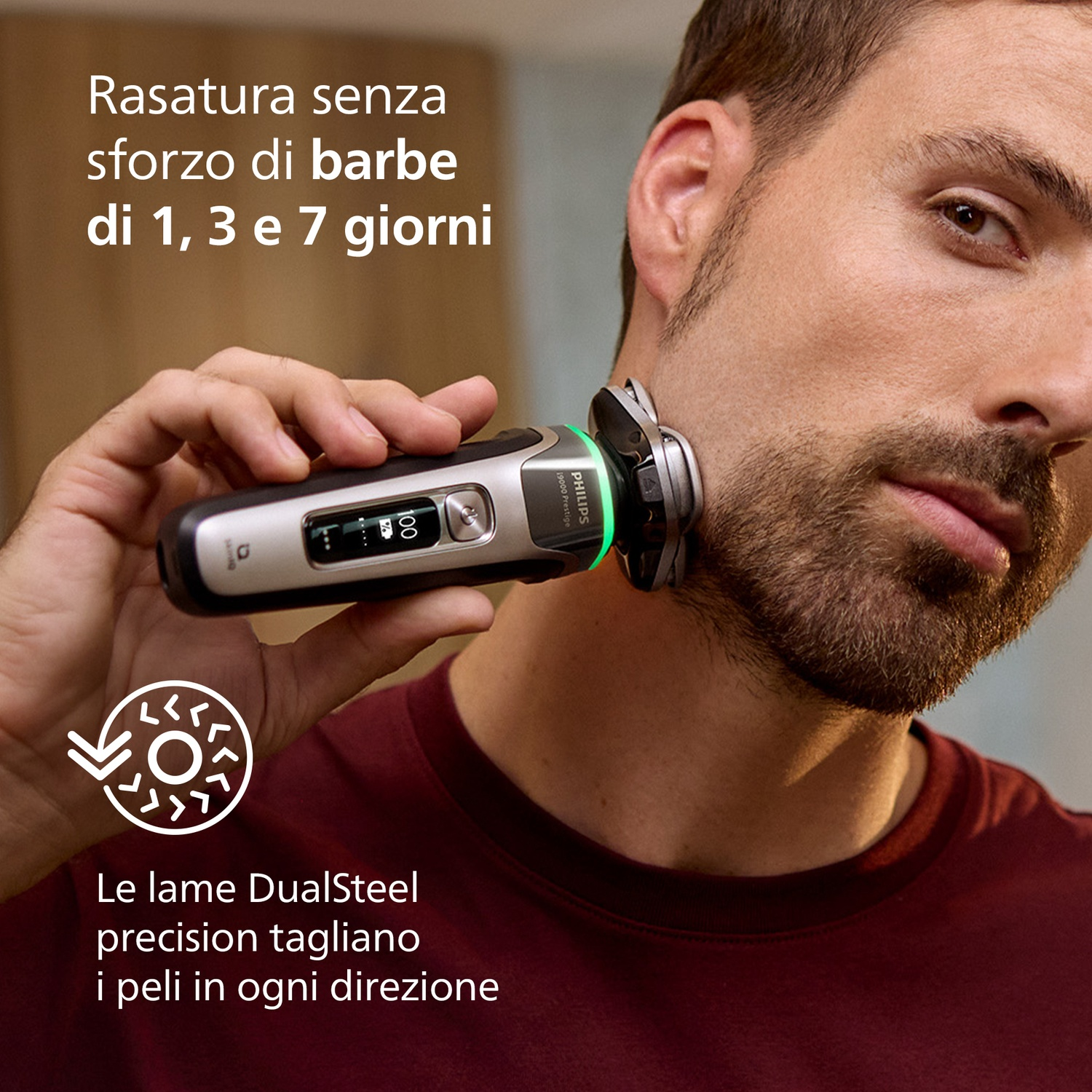 Un uomo si rade con un rasoio Philips argentato. Le lame tagliano i peli in ogni direzione.