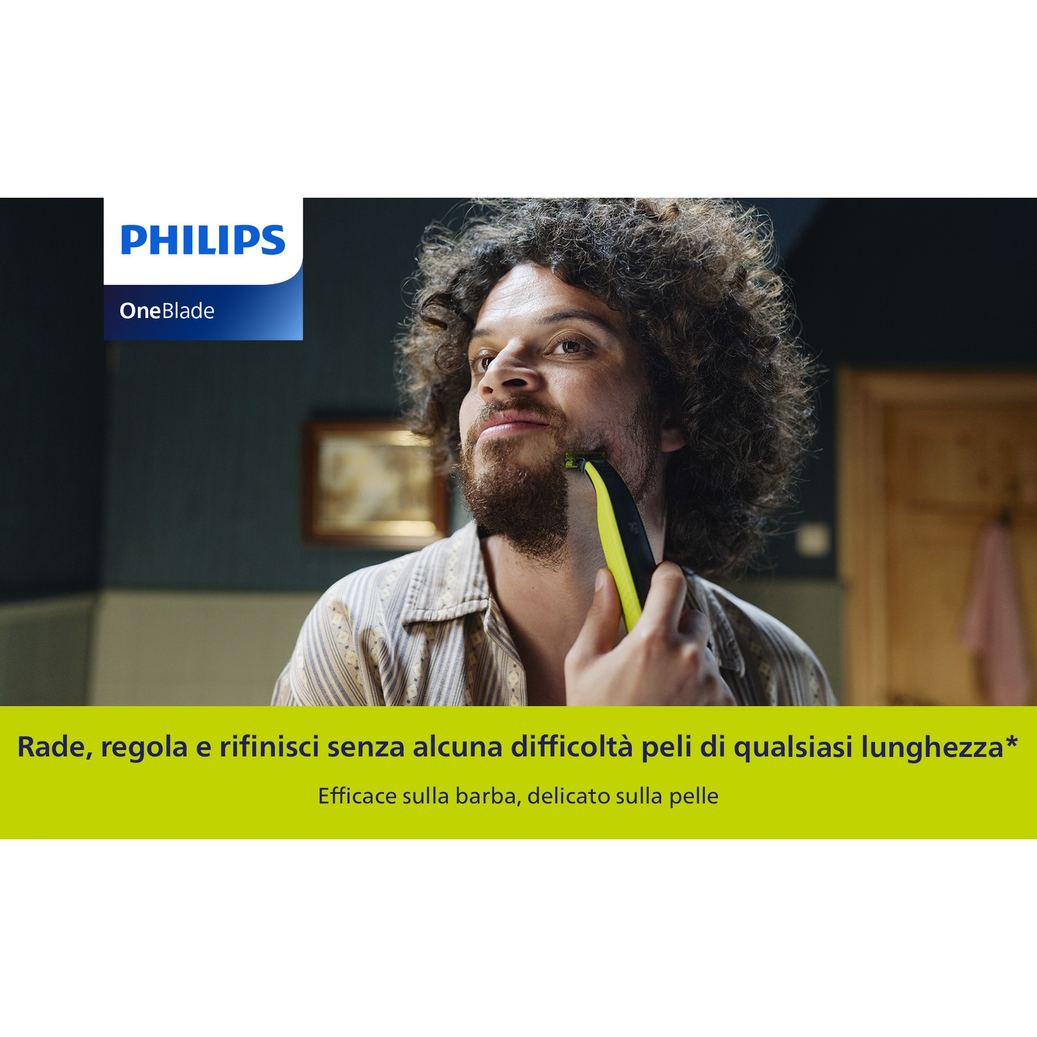Uomo con capelli ricci usa rifinitore Philips OneBlade sul viso.