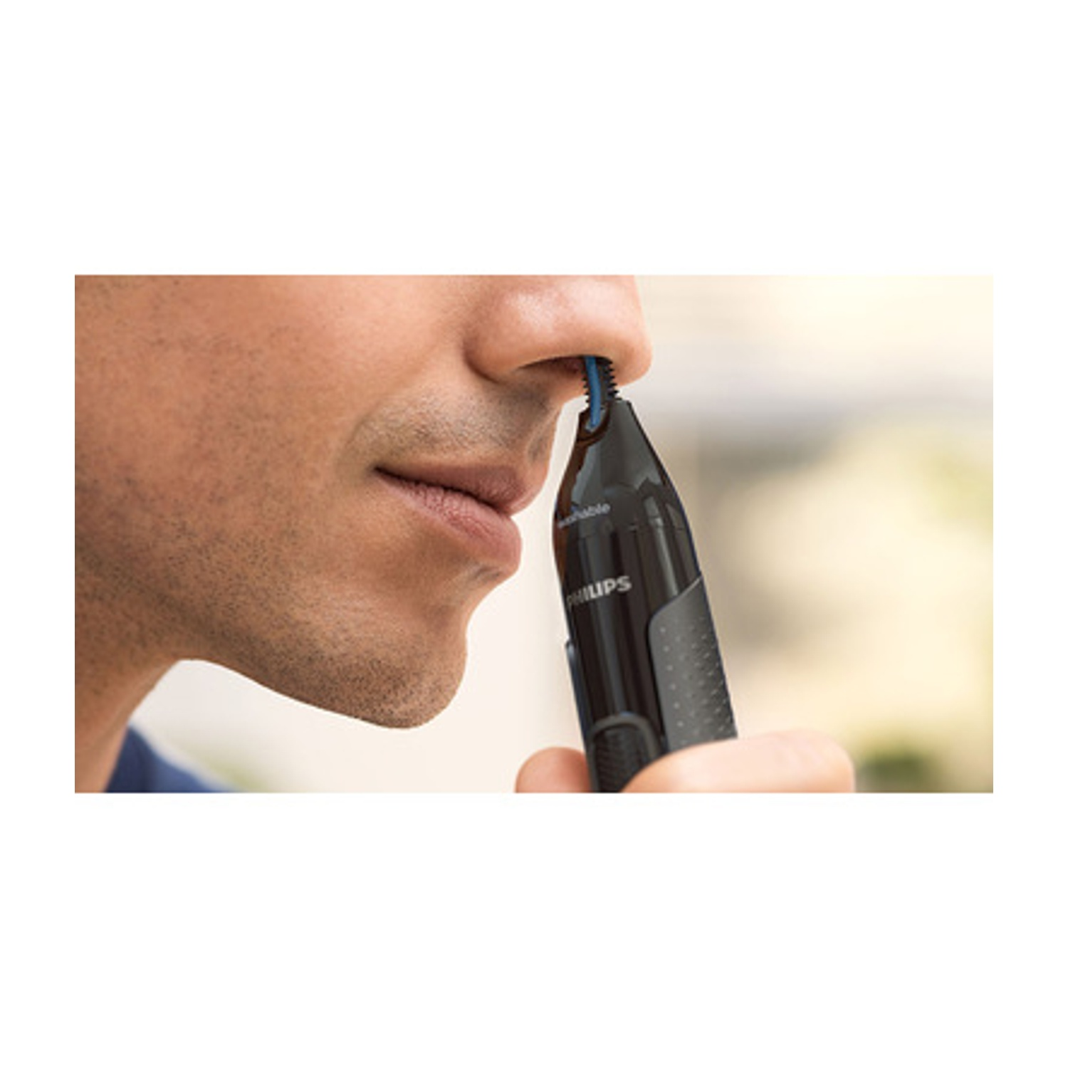 Uomo che usa un rifinitore nasale Philips inserito nella narice.